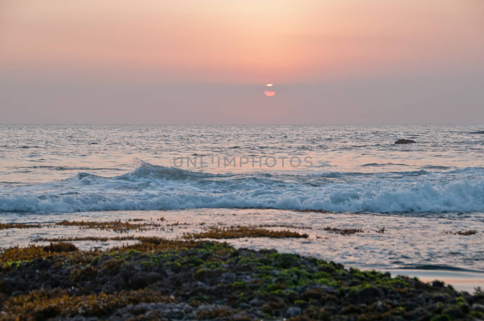 Evening sunset scene at Tanah Lot beach in Bali