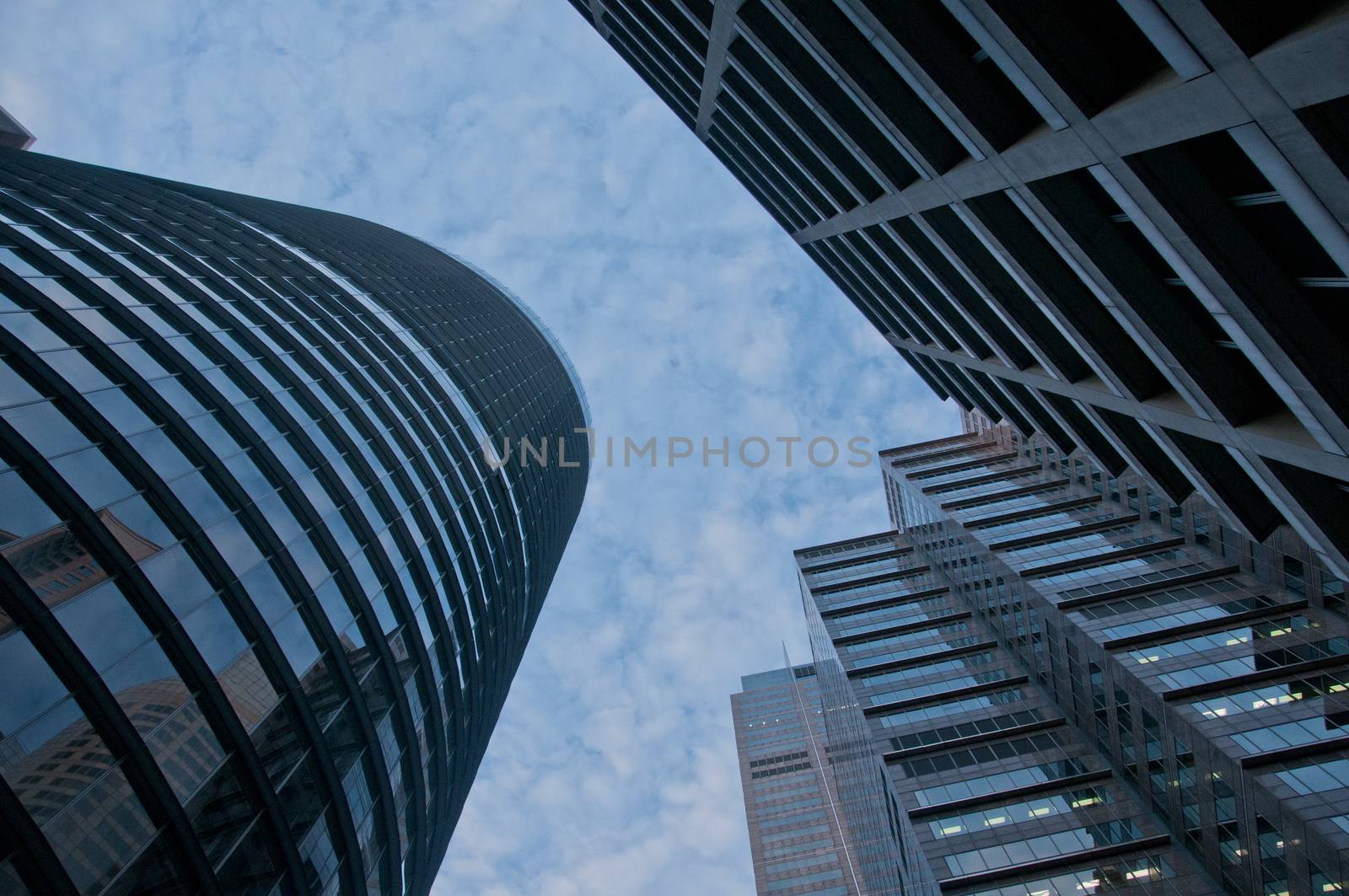 Look up on high sky and modern corporate office buildings by eyeofpaul