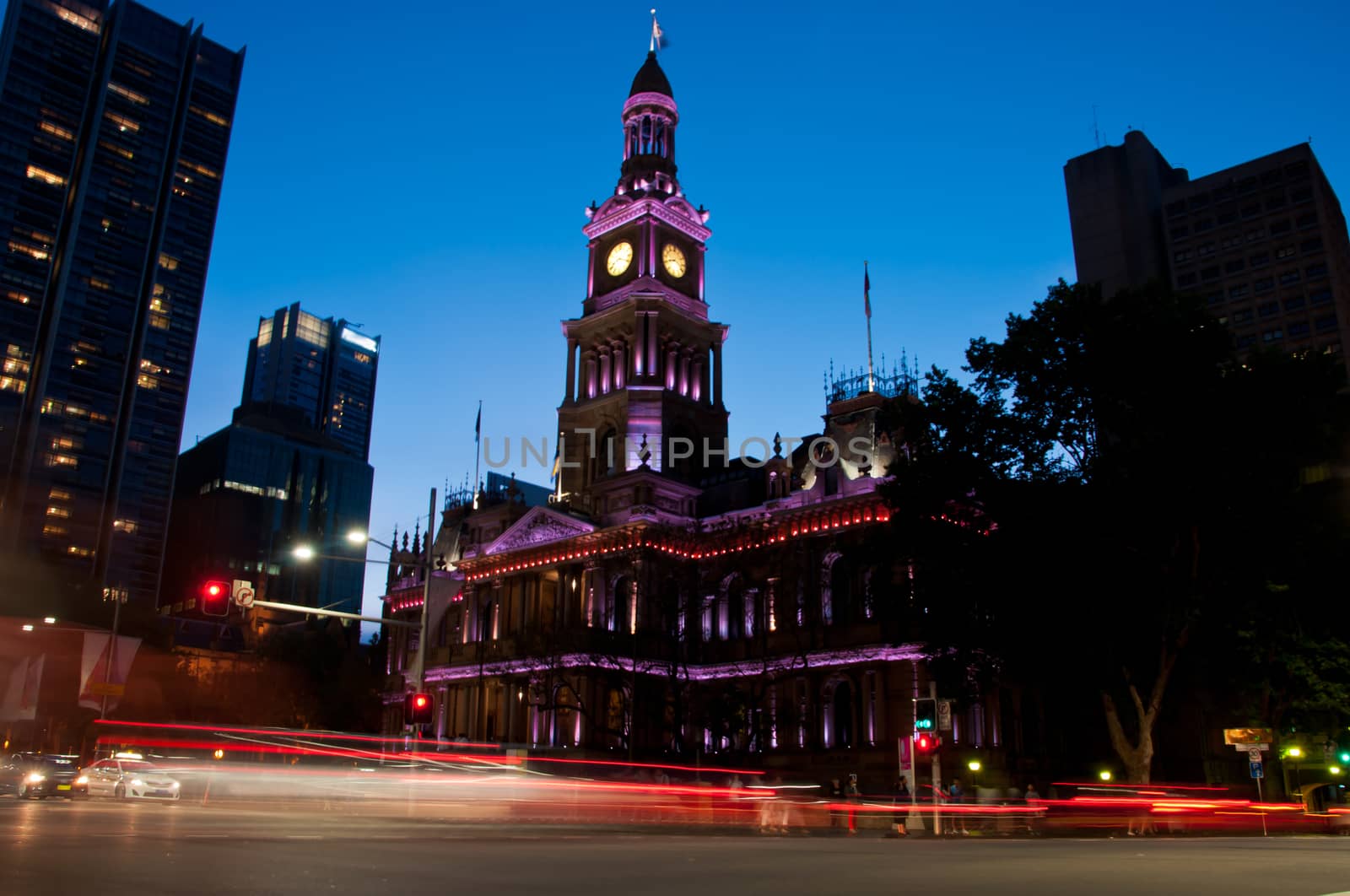 Light moving of bustling city center scene with old clock tower in Sydney