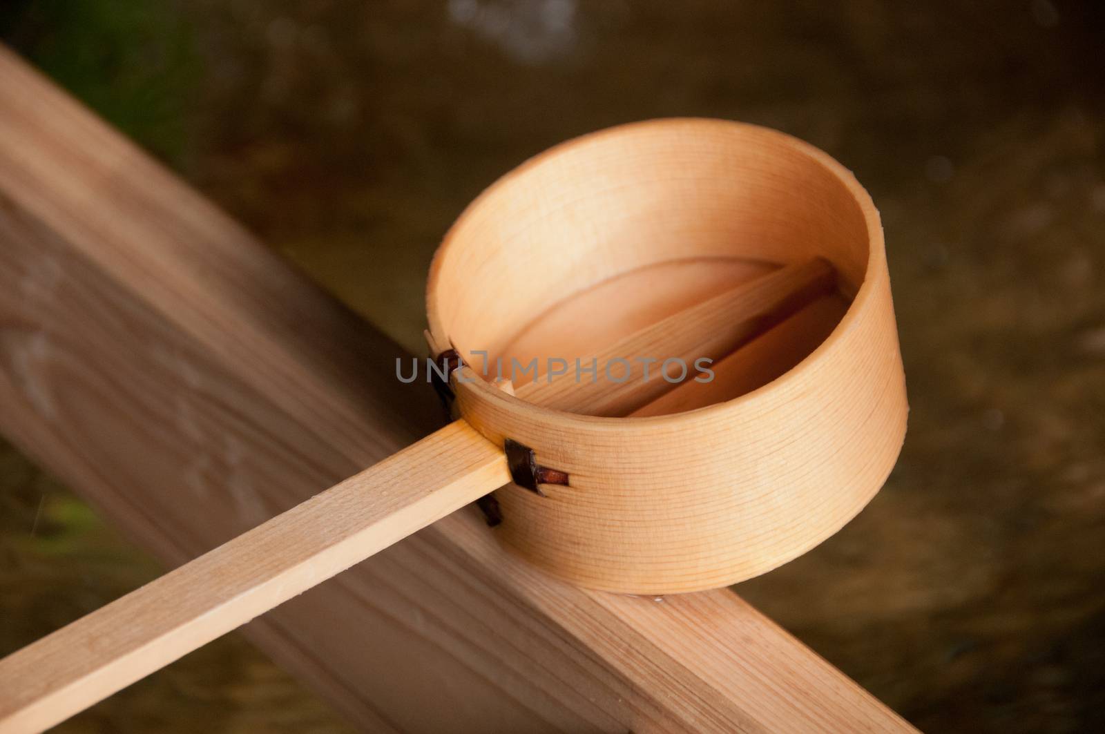 Wooden dipper of holy zen water in Japan Shinto temple by eyeofpaul