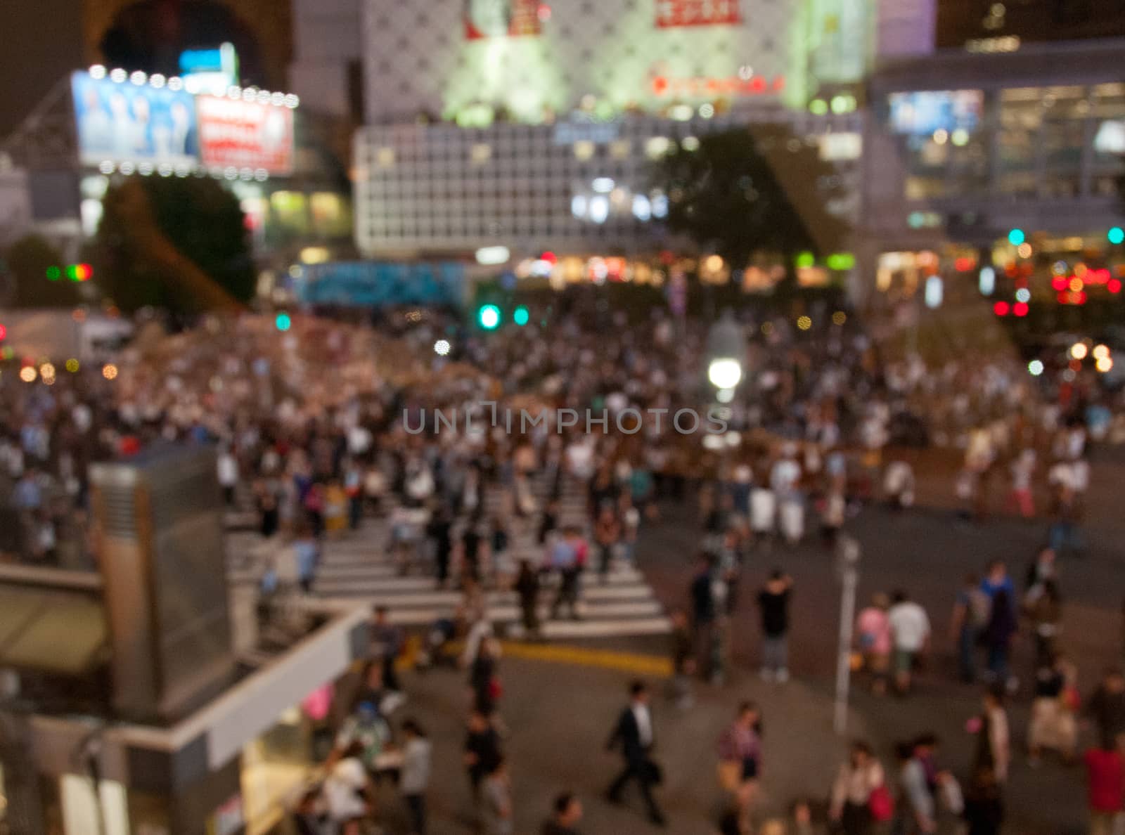 Defocused night scene of people crossing Shibuya intersection in by eyeofpaul