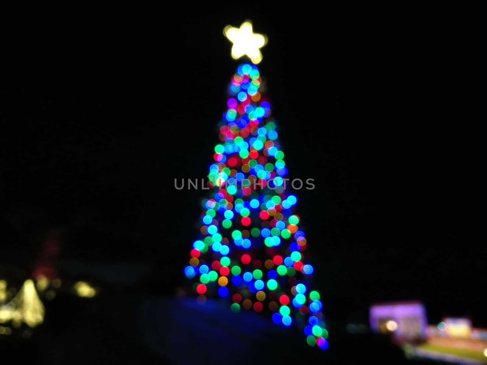 Defocused abstract light Christmas tree shape to celebrate Xmas  by eyeofpaul