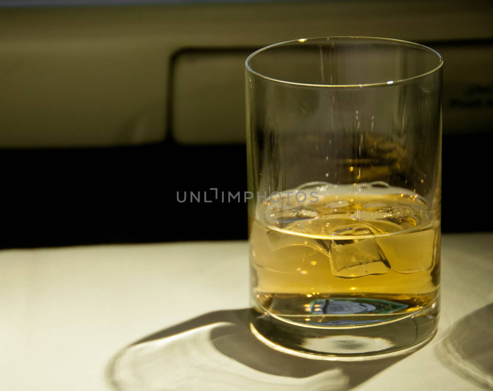 Golden malt whiskey served with ice on a table