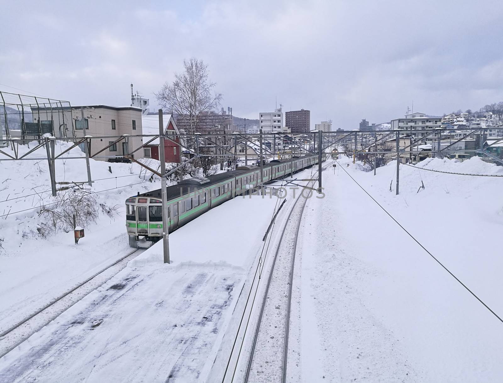 Snow railtrack and train in Otoru city Hokkaido Japan mid Winter by eyeofpaul