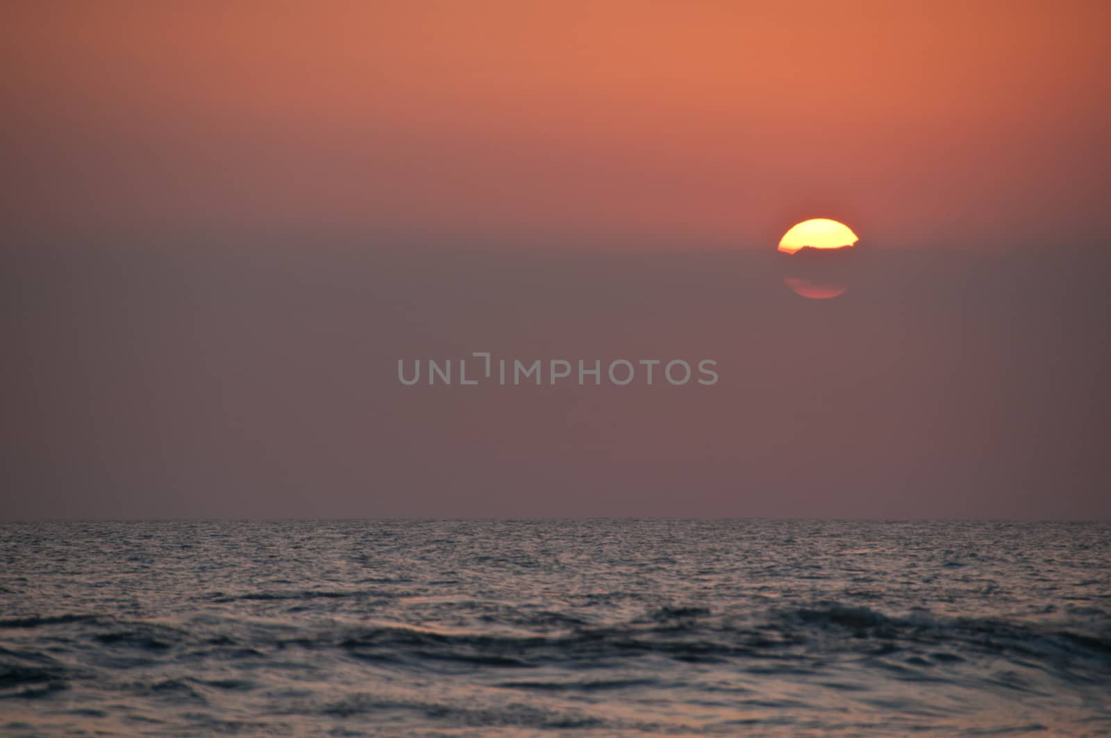 Big circle beautiful sunset on Bali sea in the evening by eyeofpaul