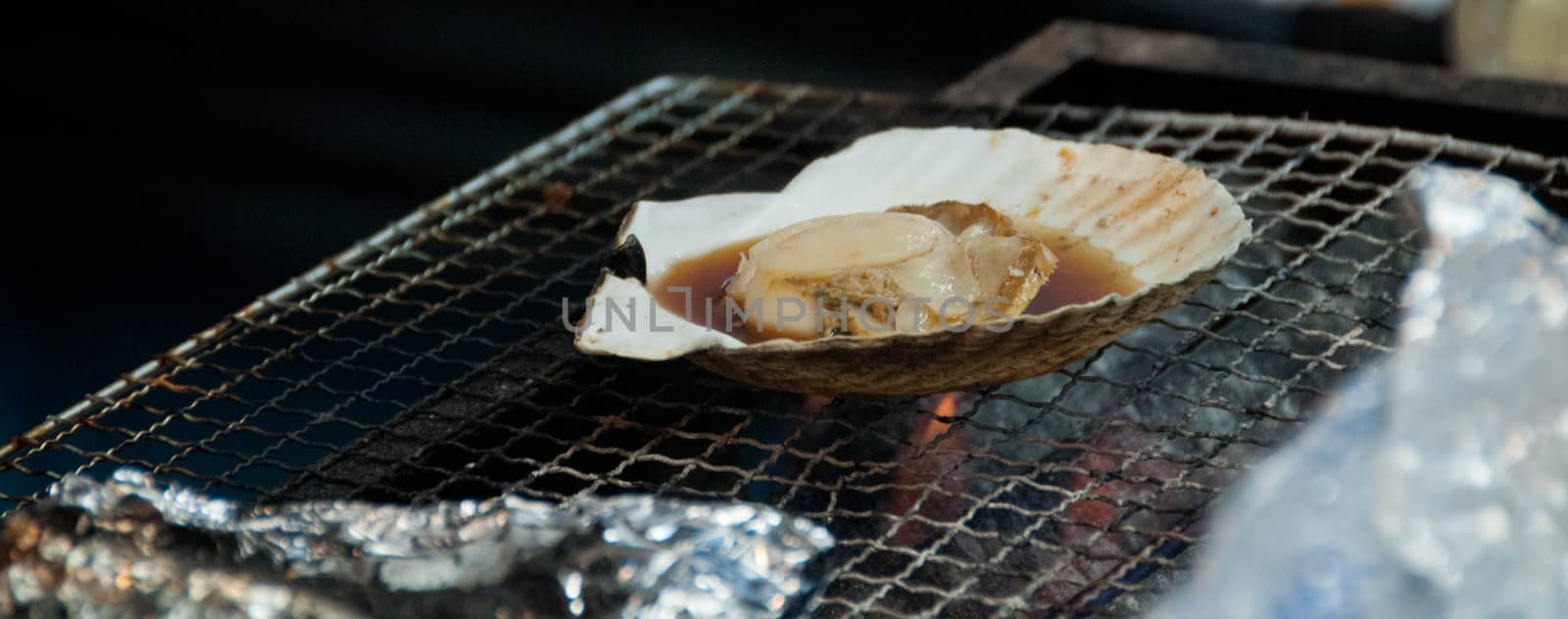 Grilled giant Hokkaido scallop on charcoal cook stove