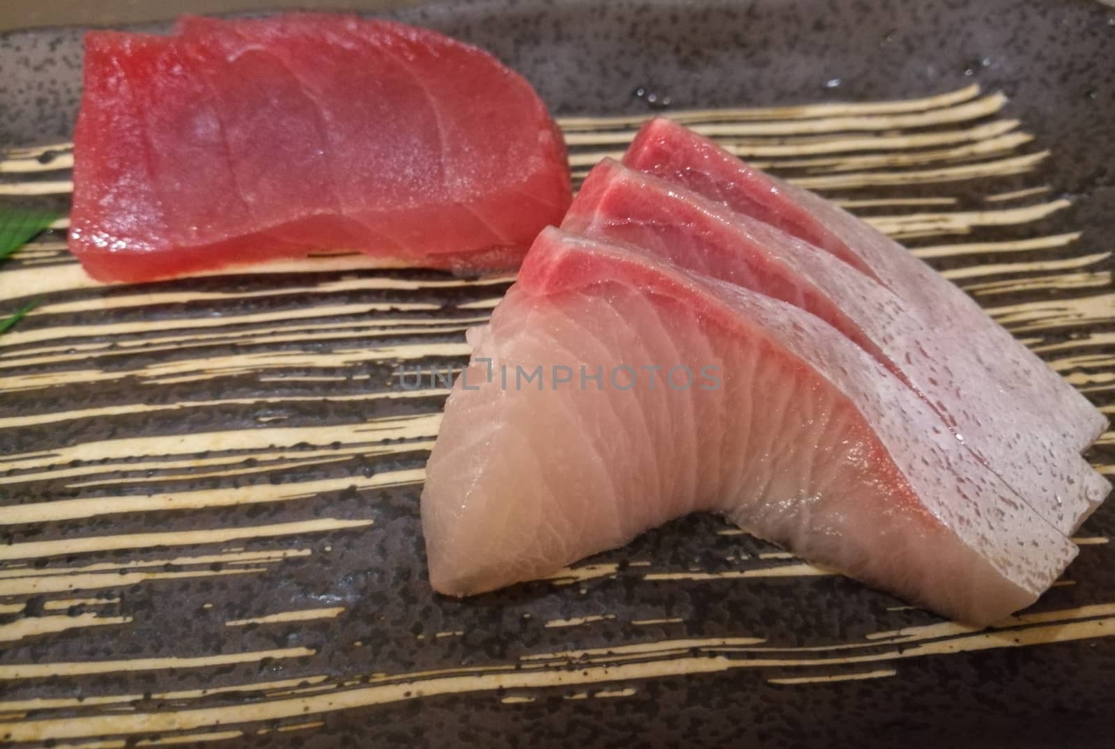 Fresh Japanese Hamachi white raw fish sashimi with tuna slice