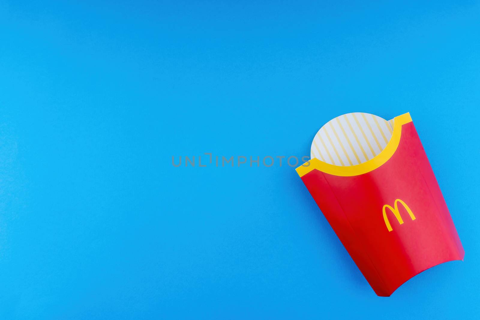 Kuala Lumpur, Malaysia - October 19, 2020 : McDonalds French fries  box on blue background