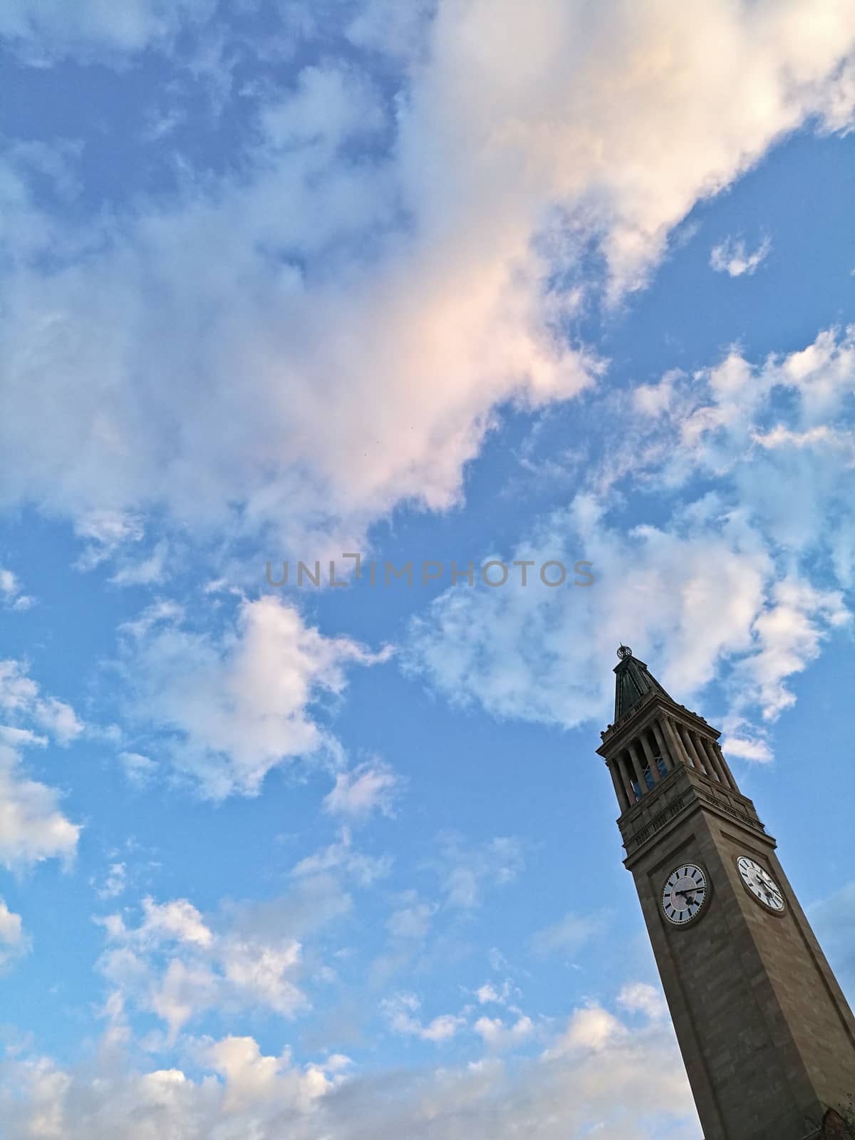 Old vintage classic tall clock tower with blue sky
