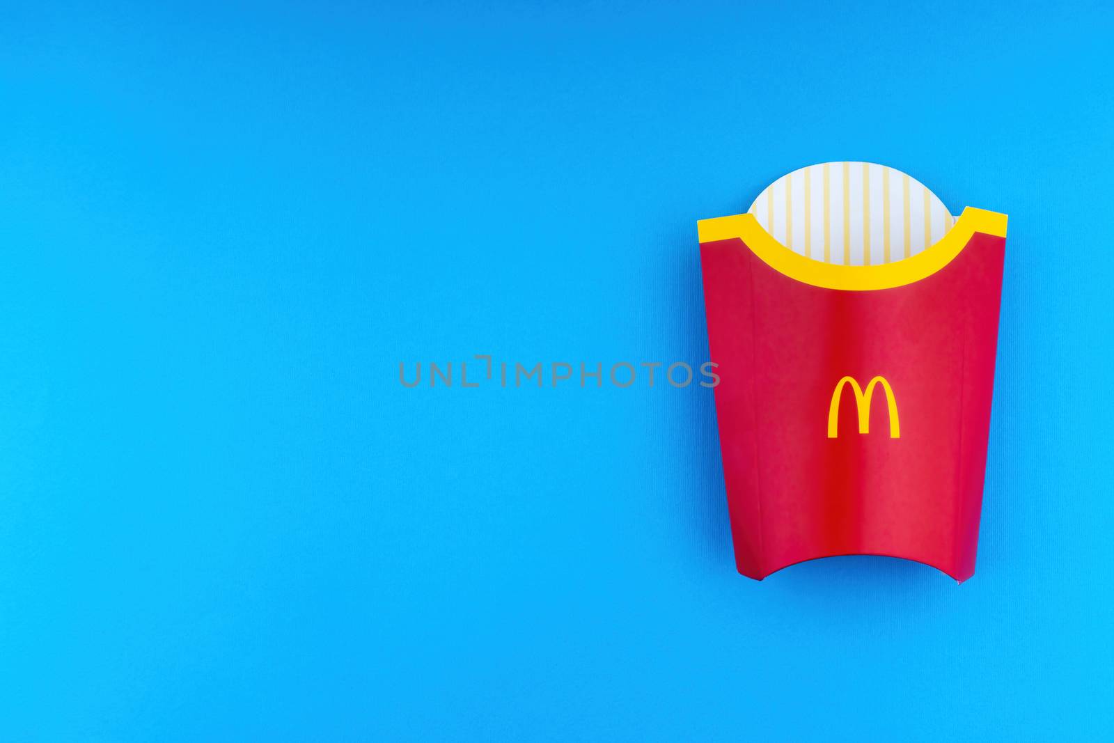 Kuala Lumpur, Malaysia - October 19, 2020 : McDonalds French fries  box on blue background by silverwings