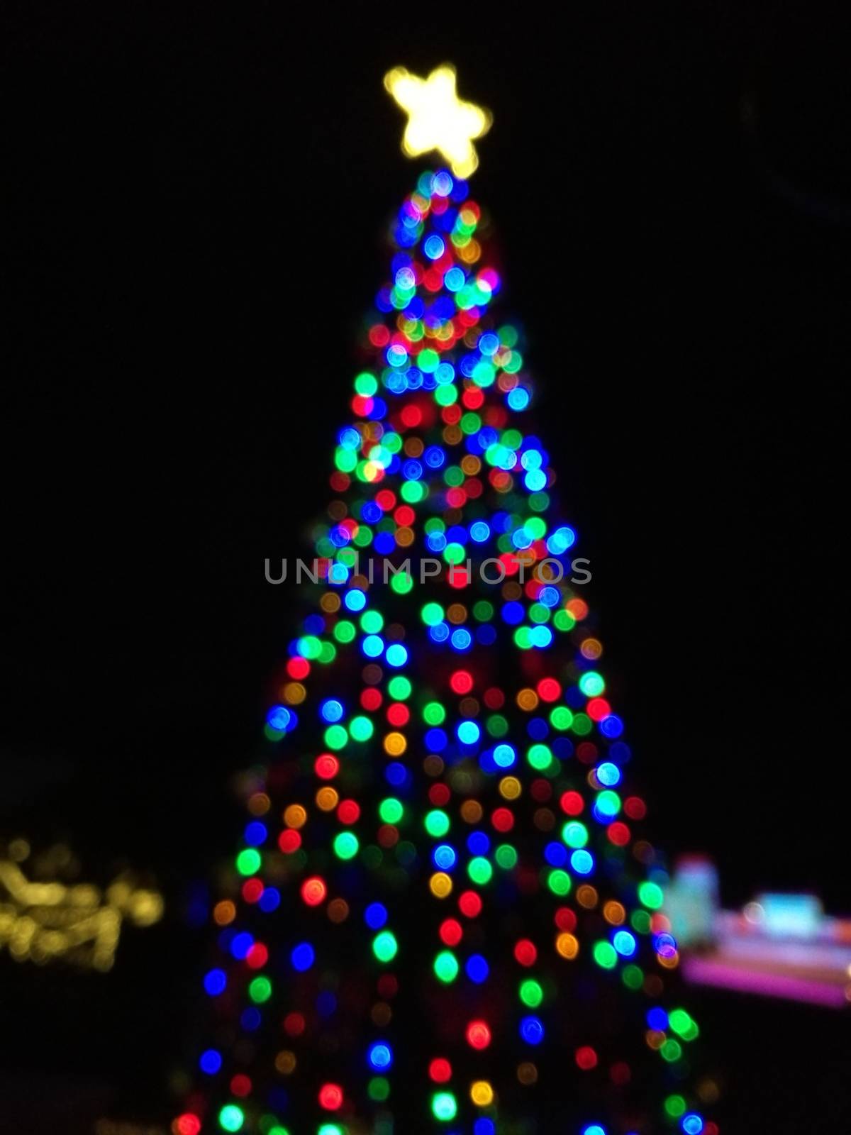 Defocused abstract light Christmas tree shape to celebrate Xmas  by eyeofpaul