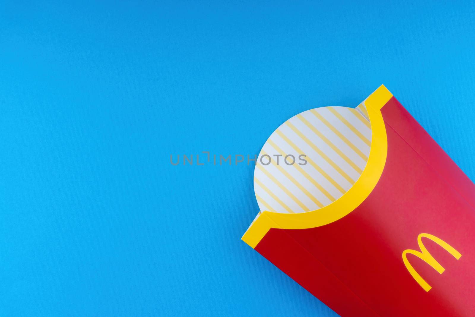 Kuala Lumpur, Malaysia - October 19, 2020 : McDonalds French fries  box on blue background by silverwings