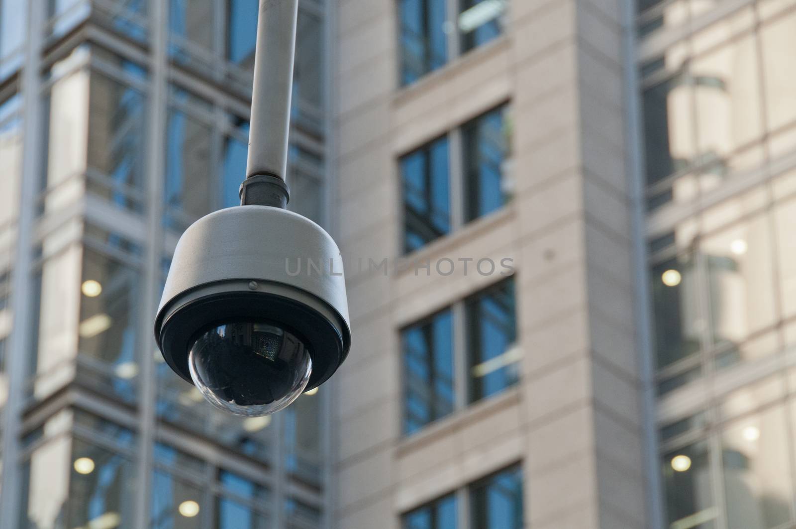 CCTV surveillance security dome camera in city center by eyeofpaul