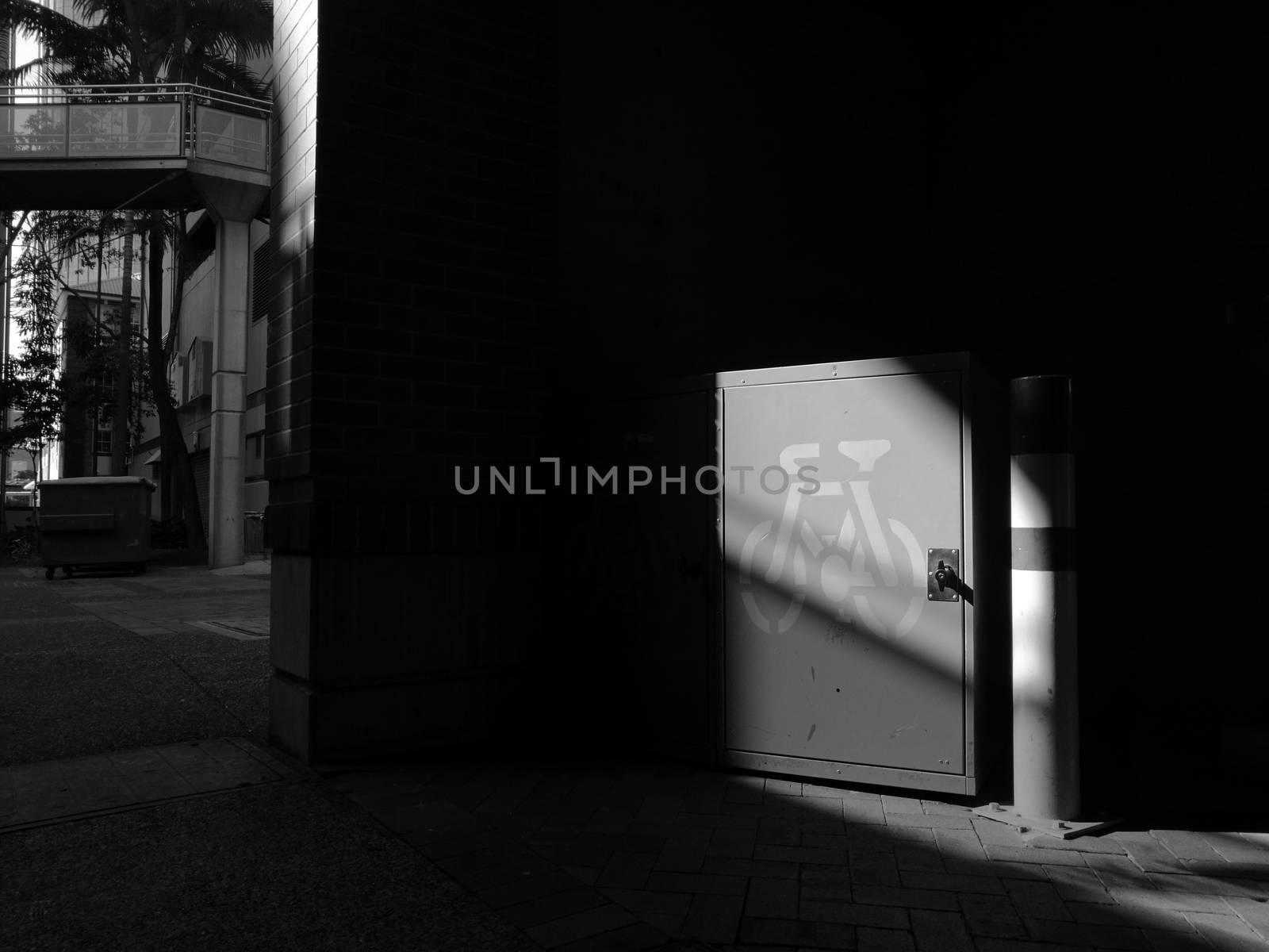 Light focus at bicycle storage shade in building in black and white