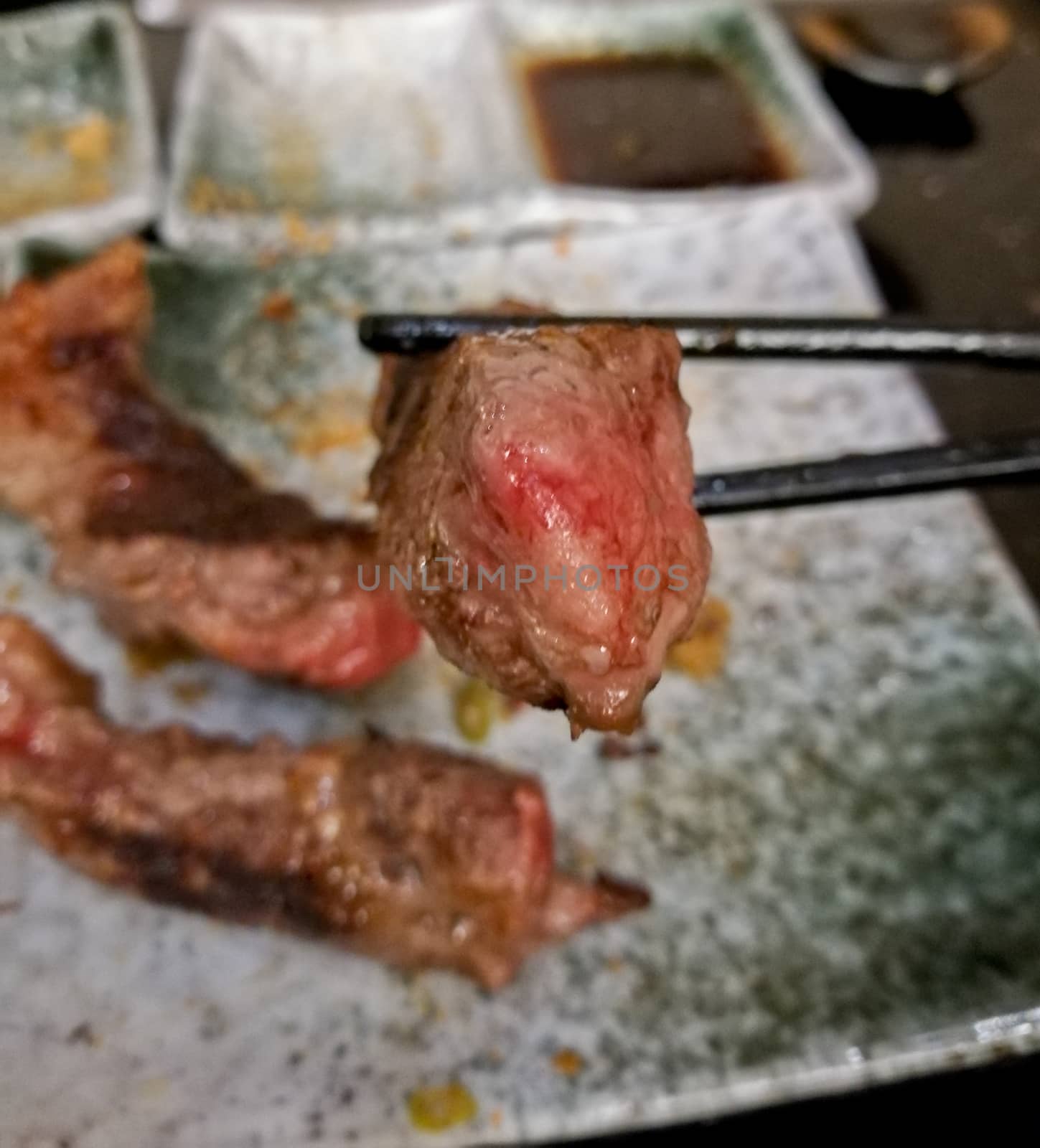 Superb legendary Wagyu beef grilled medium rare with chopsticks