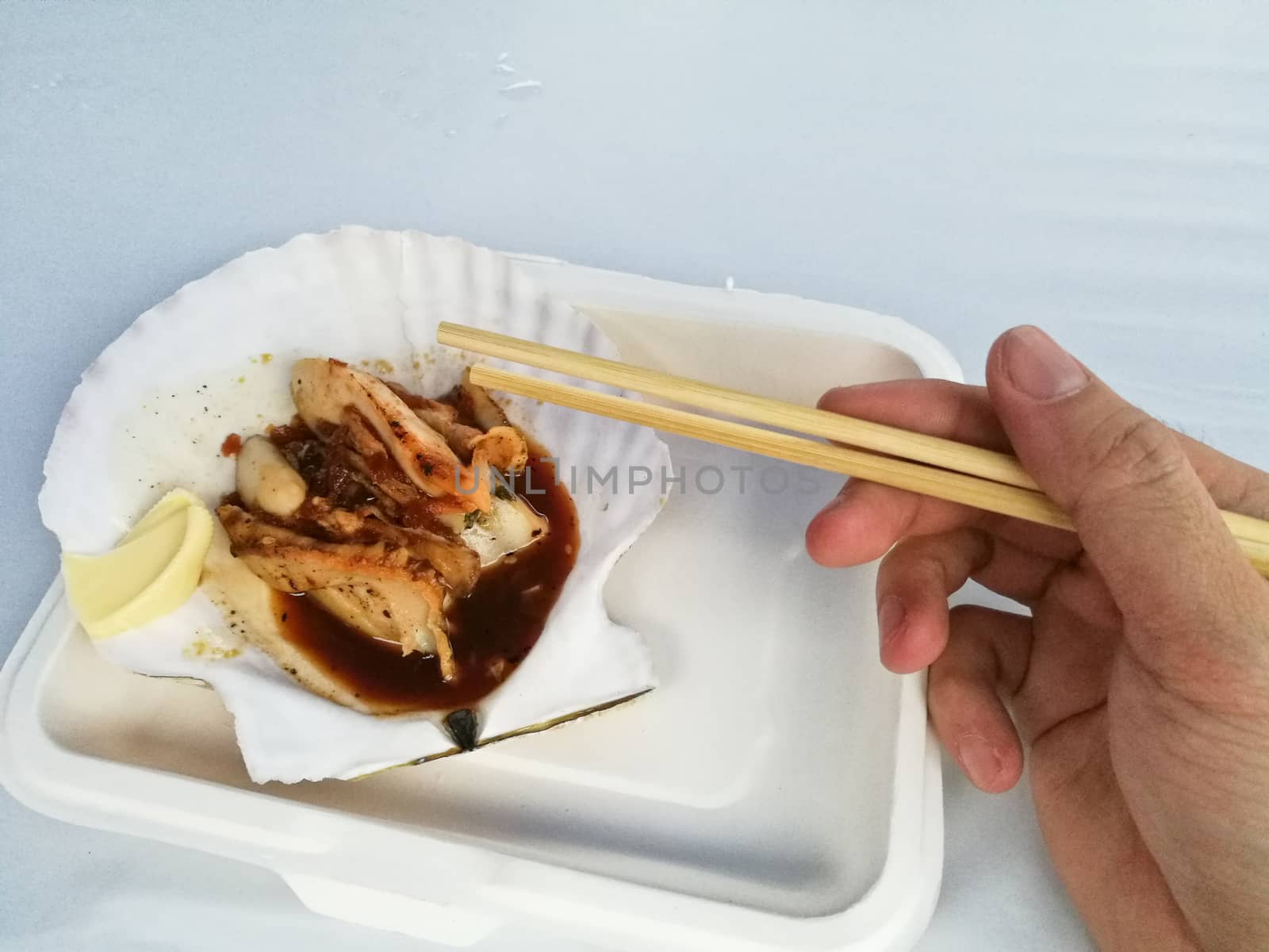 Grilled giant Hokkaido scallop takeaway with chopsticks and righ by eyeofpaul