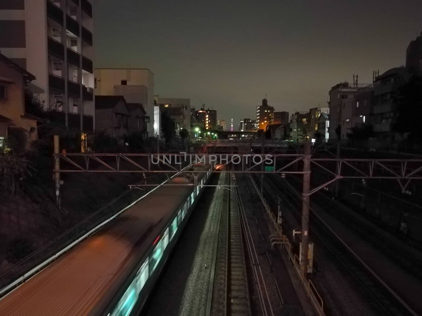 Moving motion scene of night train toward city center