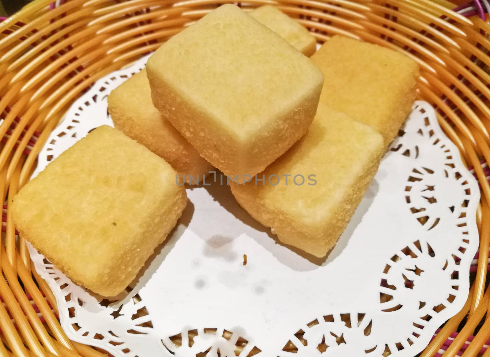 Square shape deep fried tofu in basket by eyeofpaul