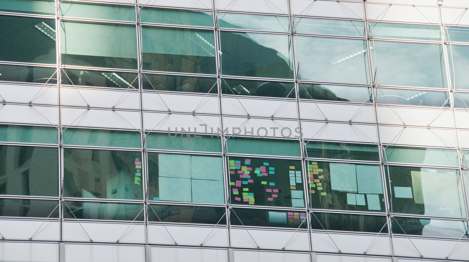 Window of corporate glass wall in city center by eyeofpaul