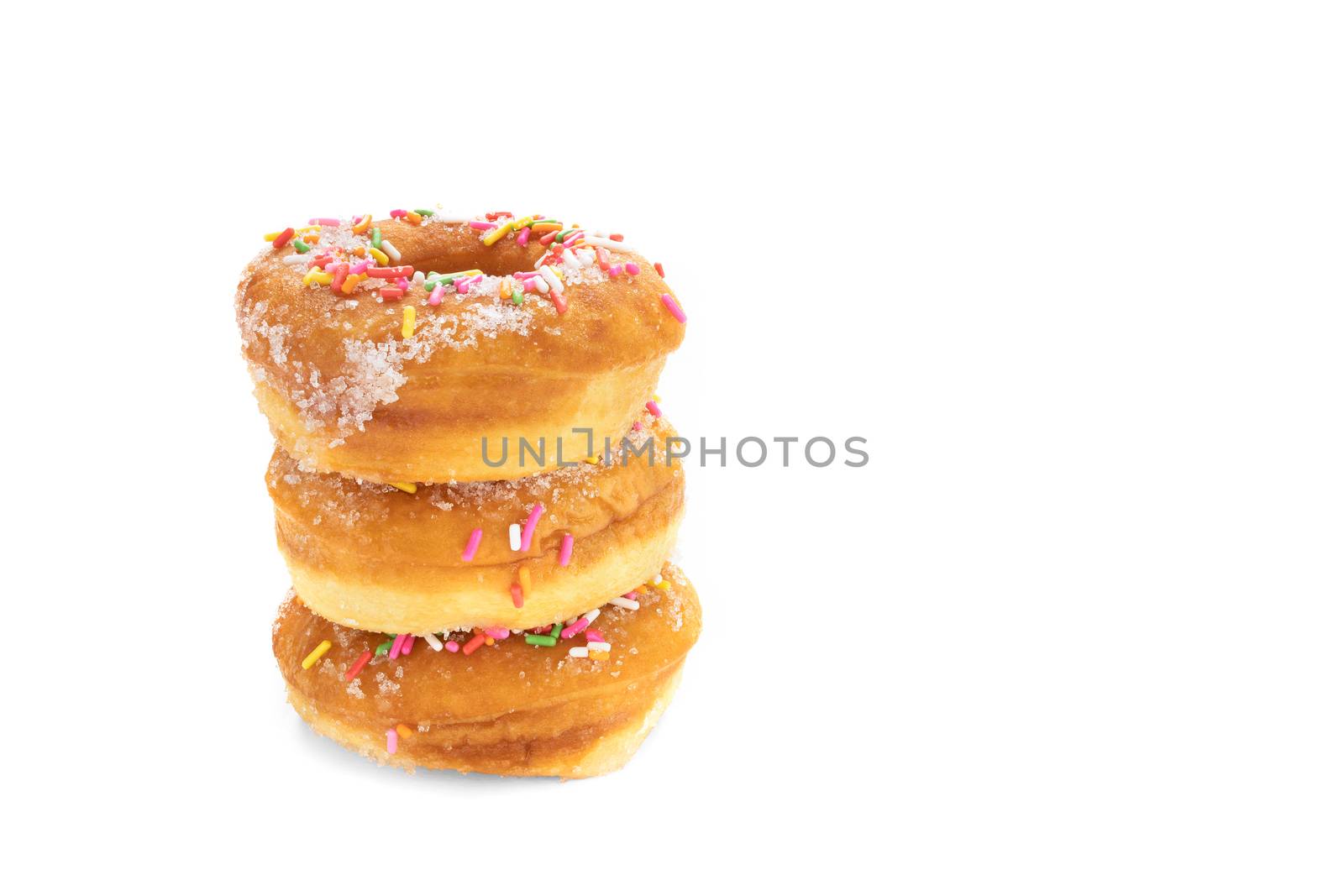 A pile of traditional sugar donuts with multi color sprinkles, isolated on white background.