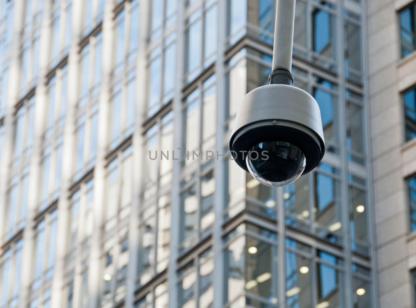 CCTV surveillance security dome camera in city center by eyeofpaul