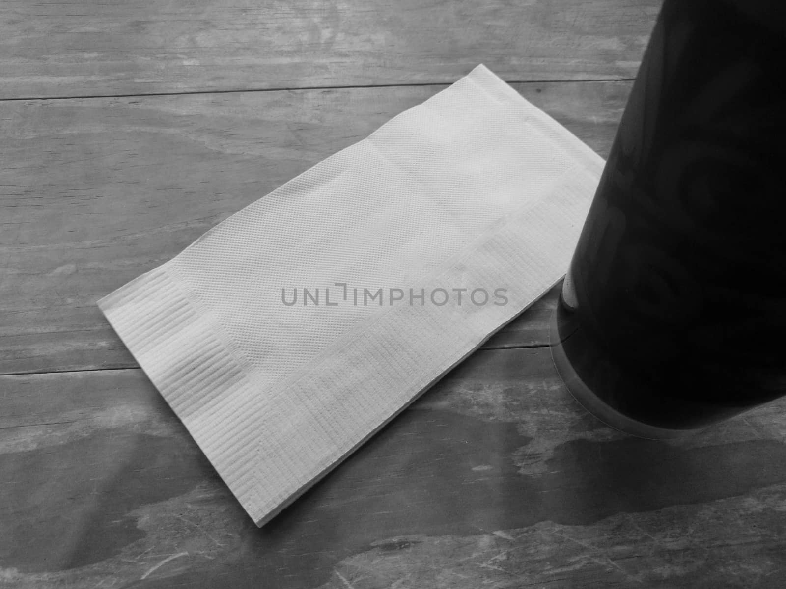 White tissue paper with black cold iced coffee in black and white
