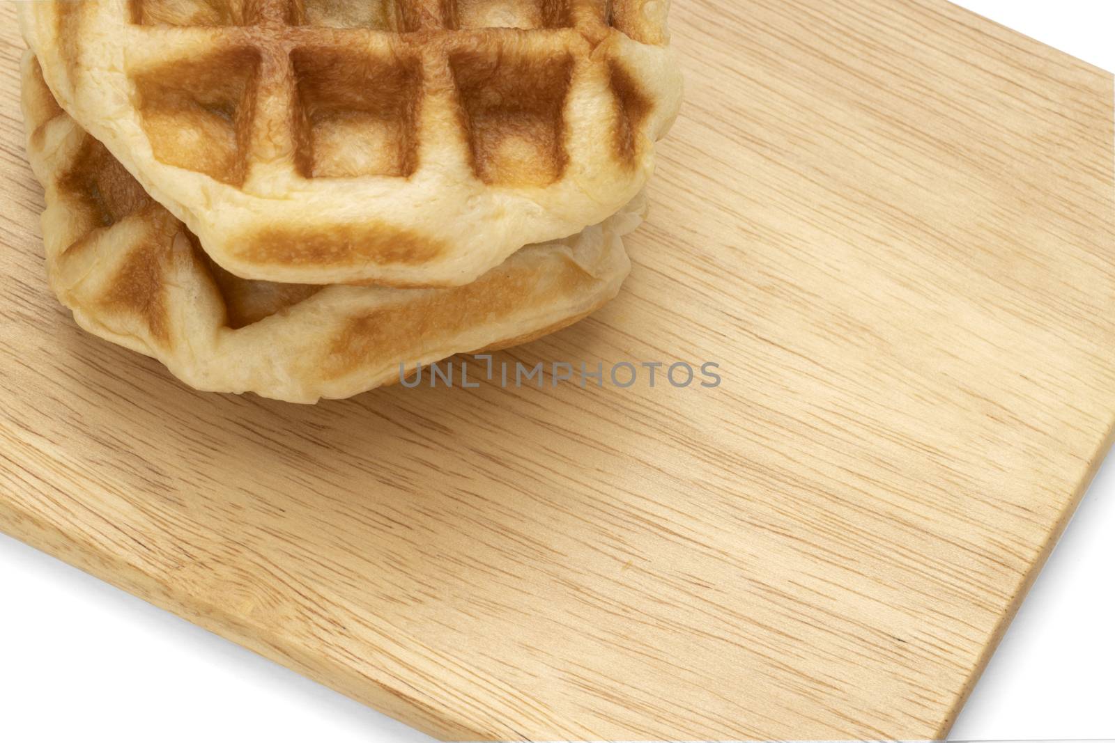 Closeup of waffles on wood by Nawoot
