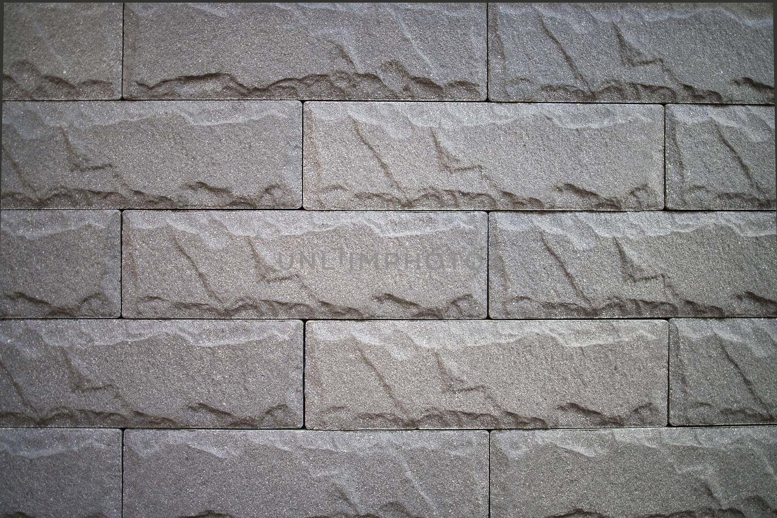 Close up of a grey wall brick background.