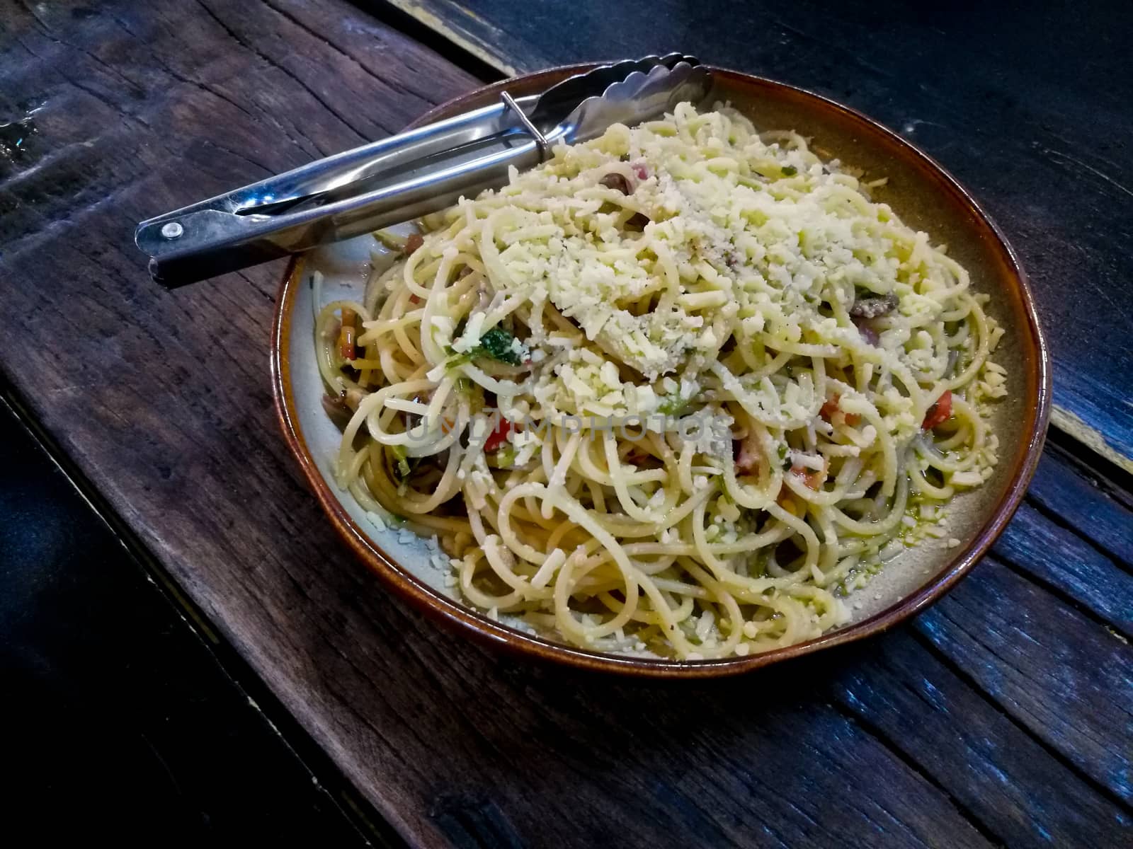 Mediterranean olive marinara sauce spaghetti on wooden table