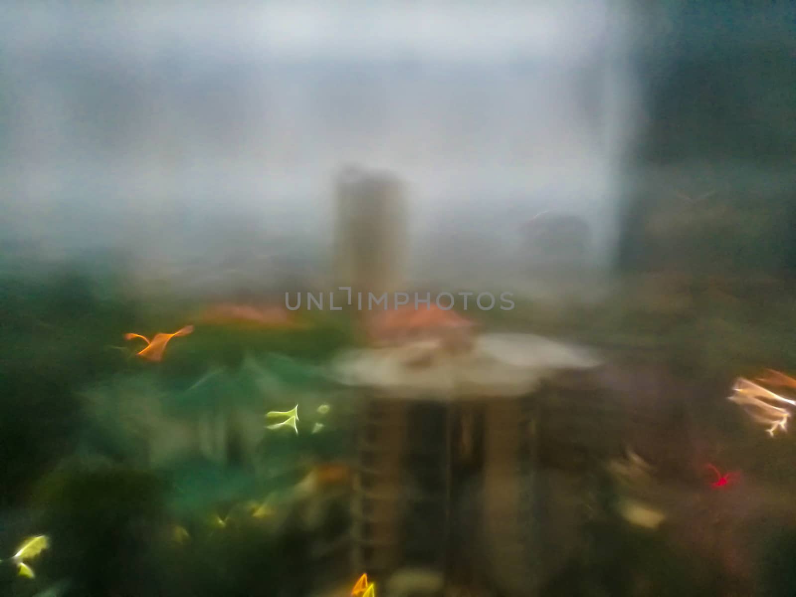 Defocused abstract scene of window outlook in rainy day evening