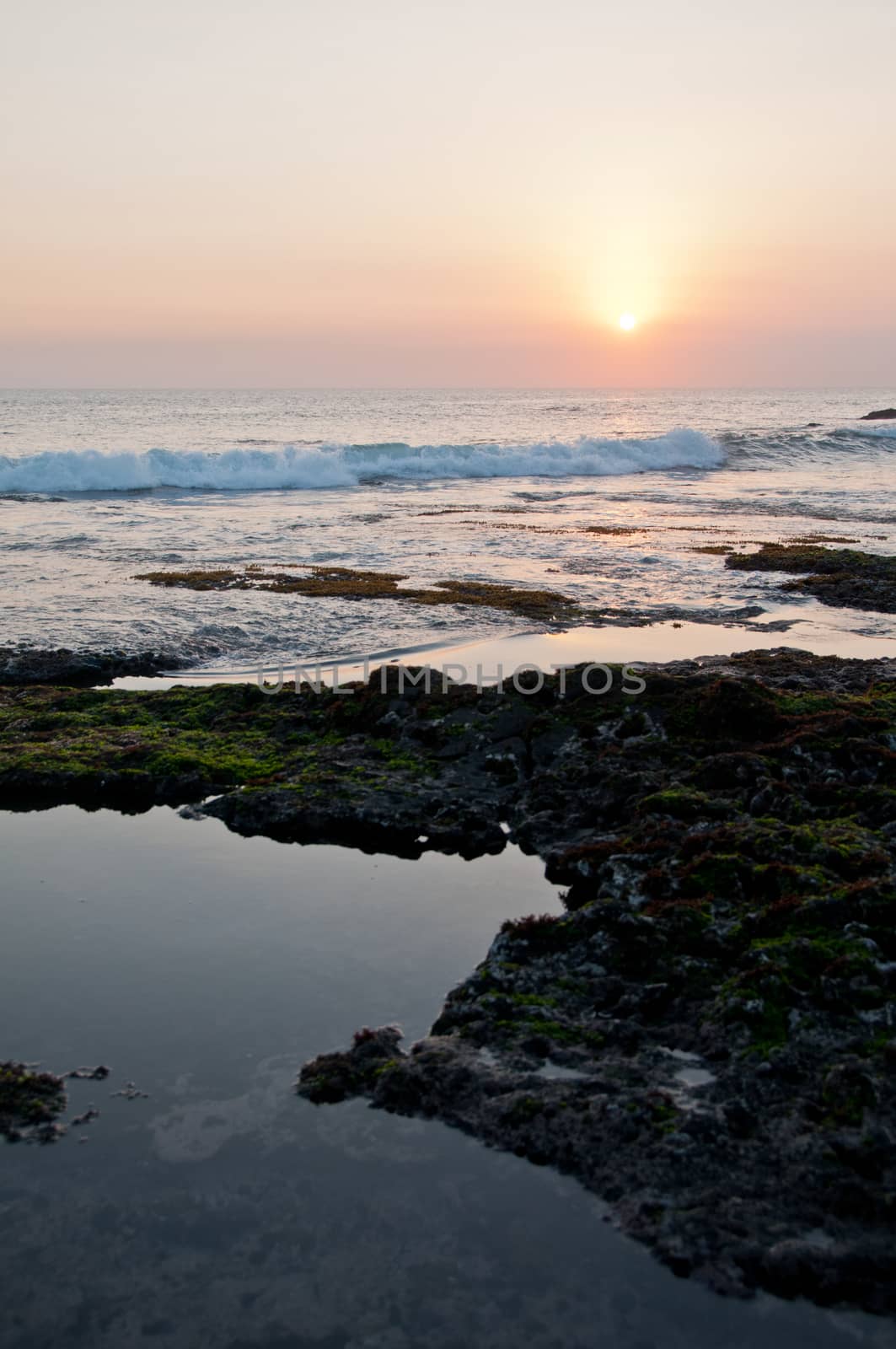 Sunset scene at Tanah Lot beach in Bali Indonesia sea in the evening