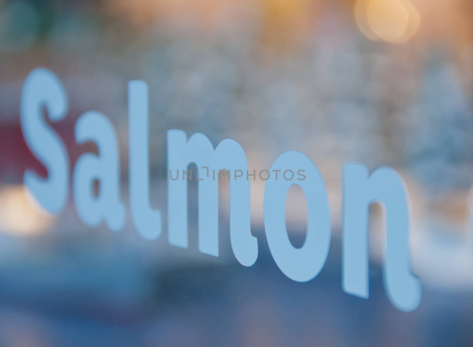 Salmon text in white font in front of supermarket by eyeofpaul