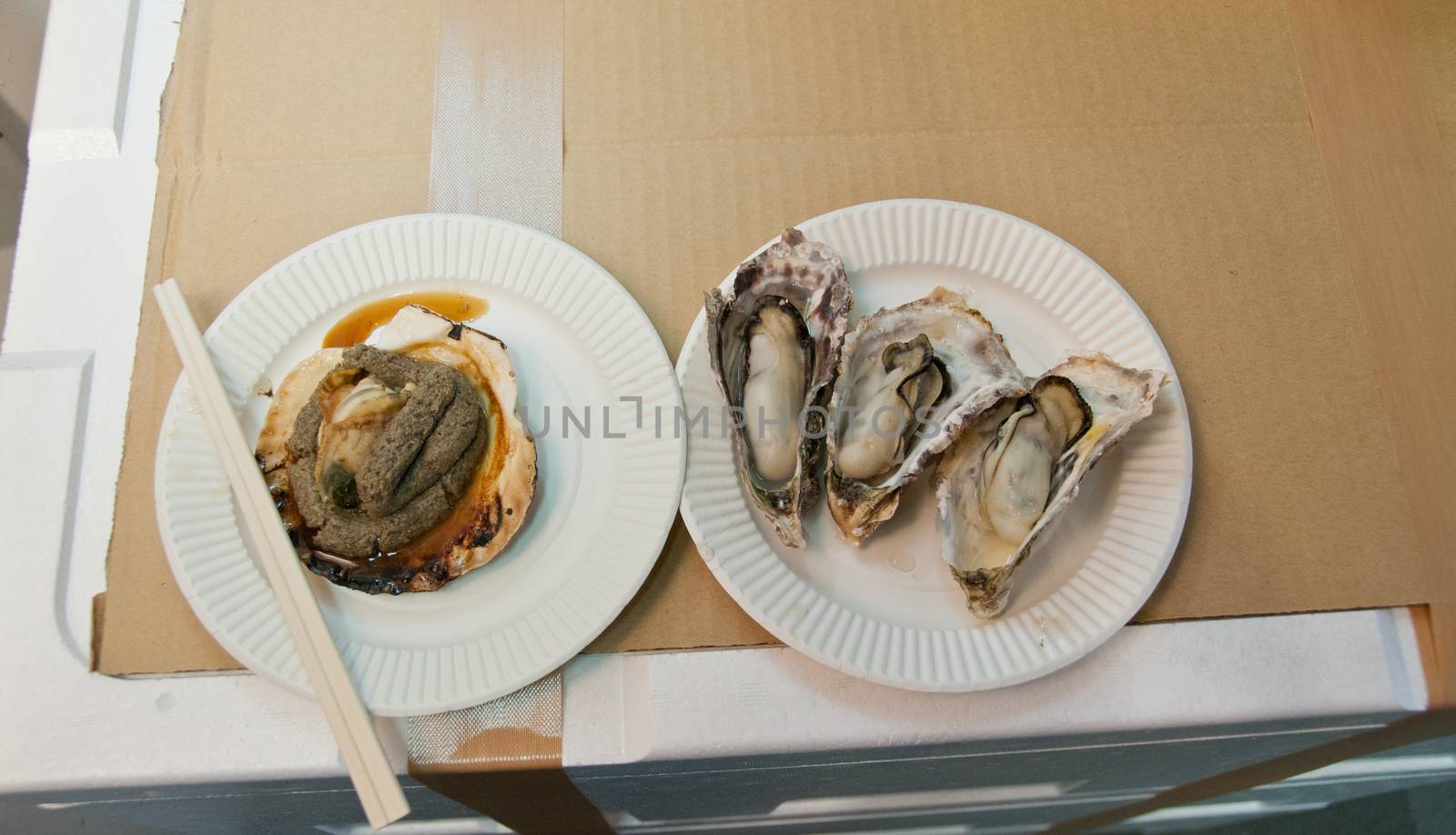 Giant oysters and grilled scallop at Tsukuji Tokyo fish market by eyeofpaul