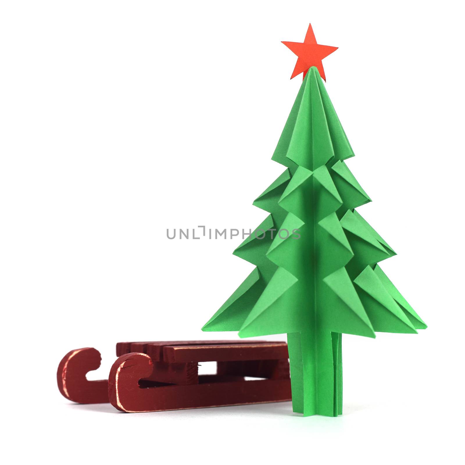 Origami Christmas tree of green craft paper isolated on white background