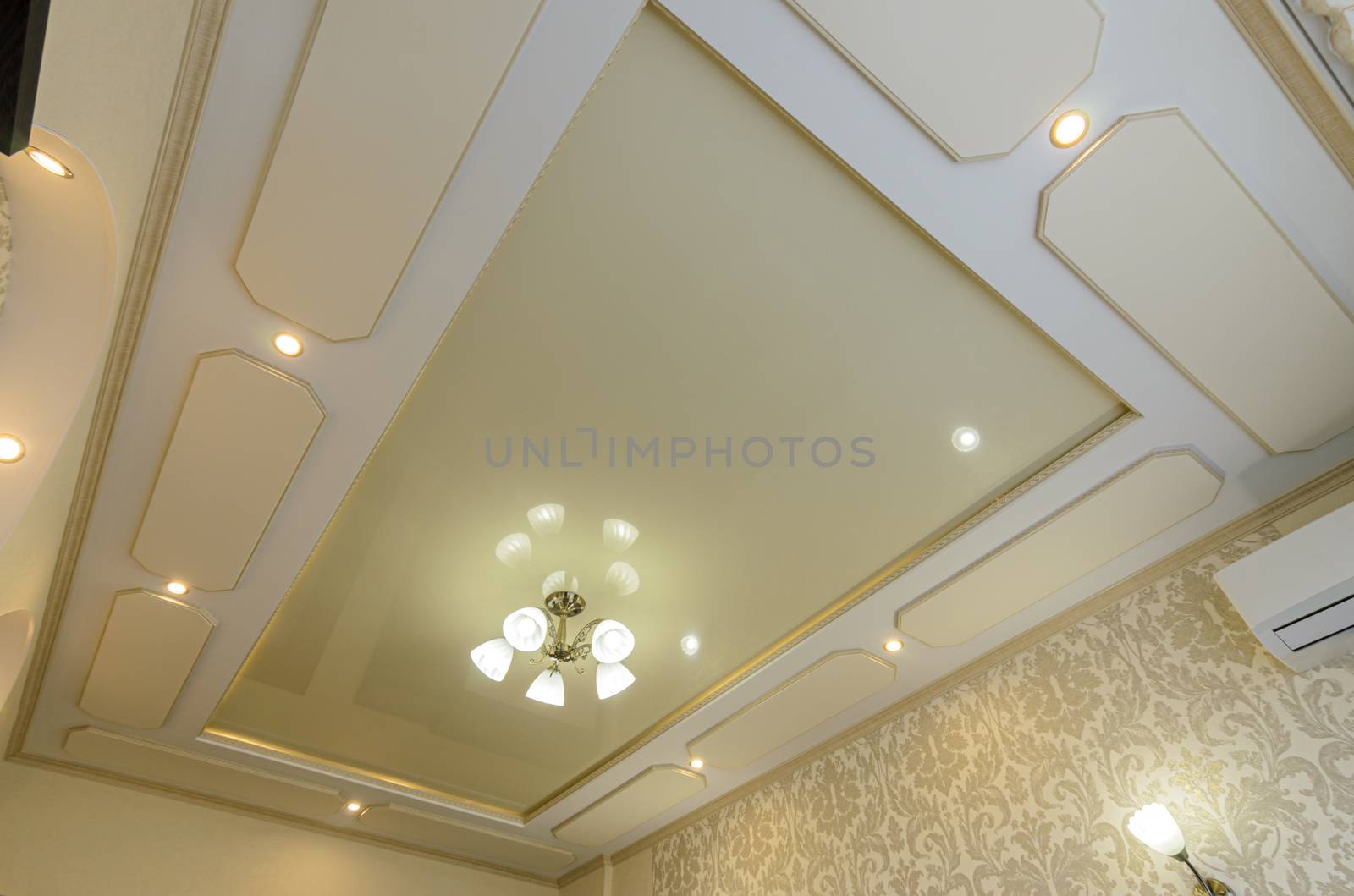 Original multi-level stretch ceiling with plasterboard elements in the bedroom interior