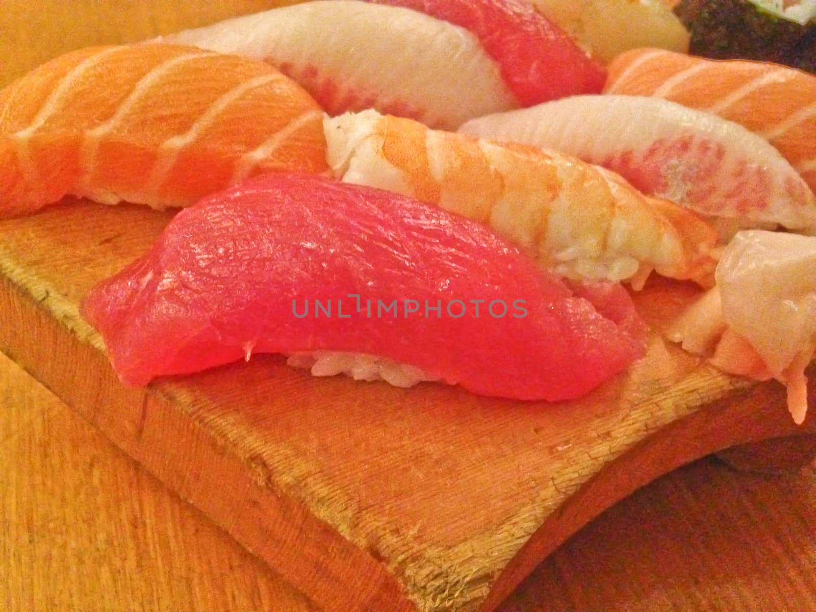 Mixed fresh Japanese sushi platter served on wooden plate by eyeofpaul