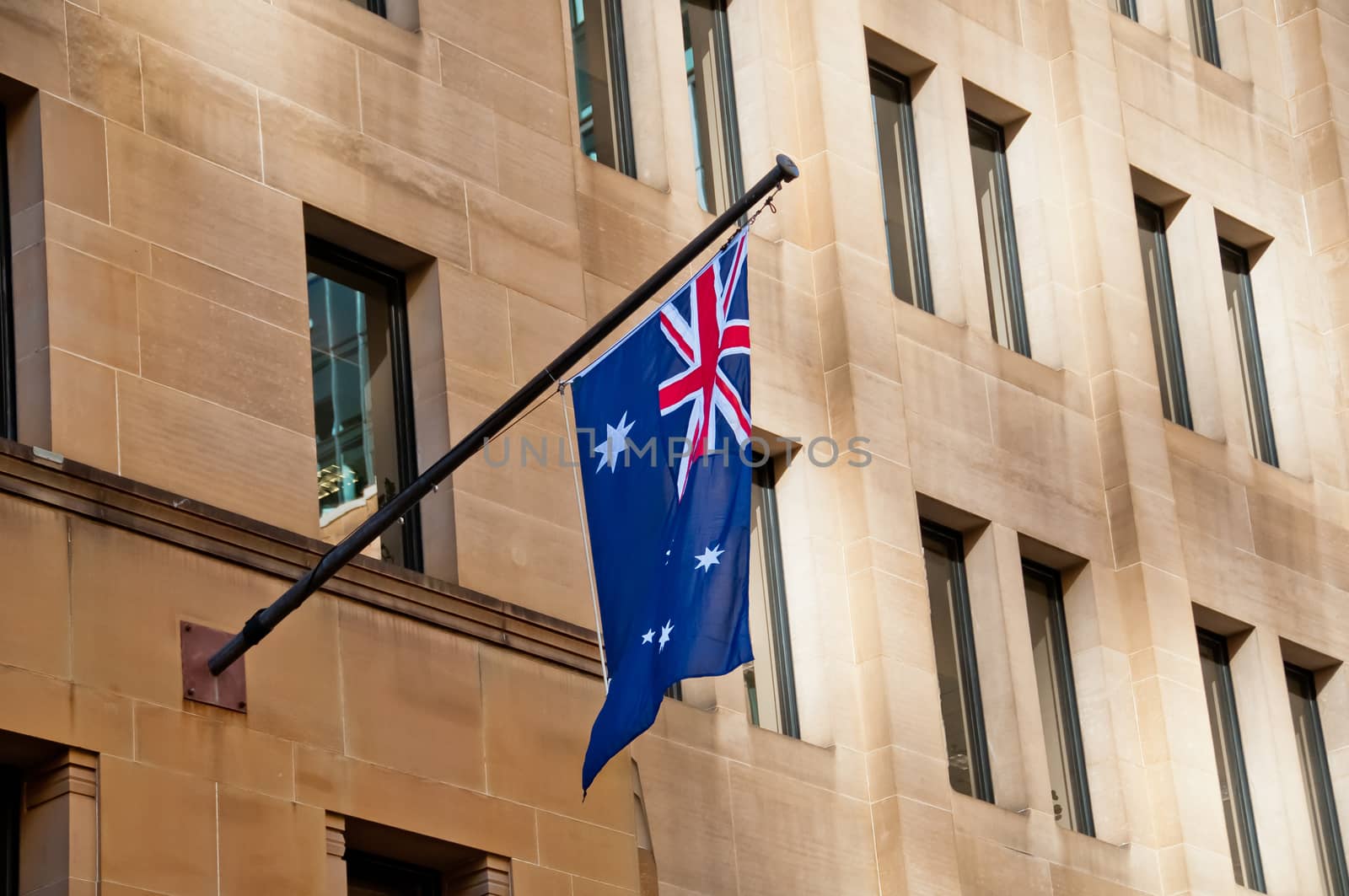 Flag of Australia hang from a sandstone building