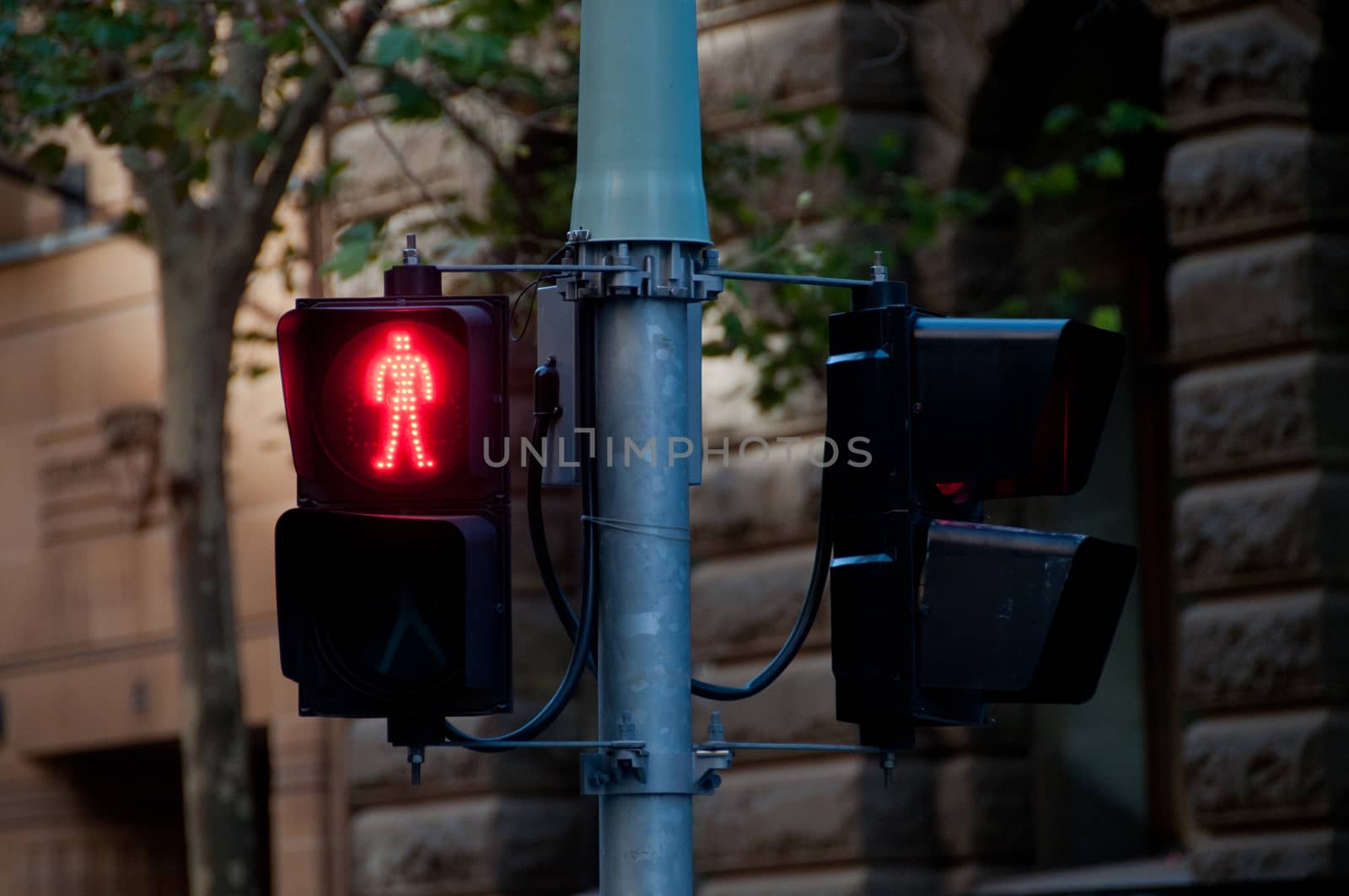 Red man traffic light signal on the pole to stop