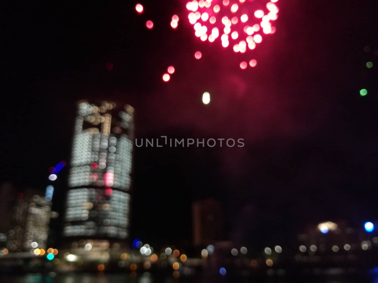 Defocused abstract scene of riverside firework in city center at by eyeofpaul