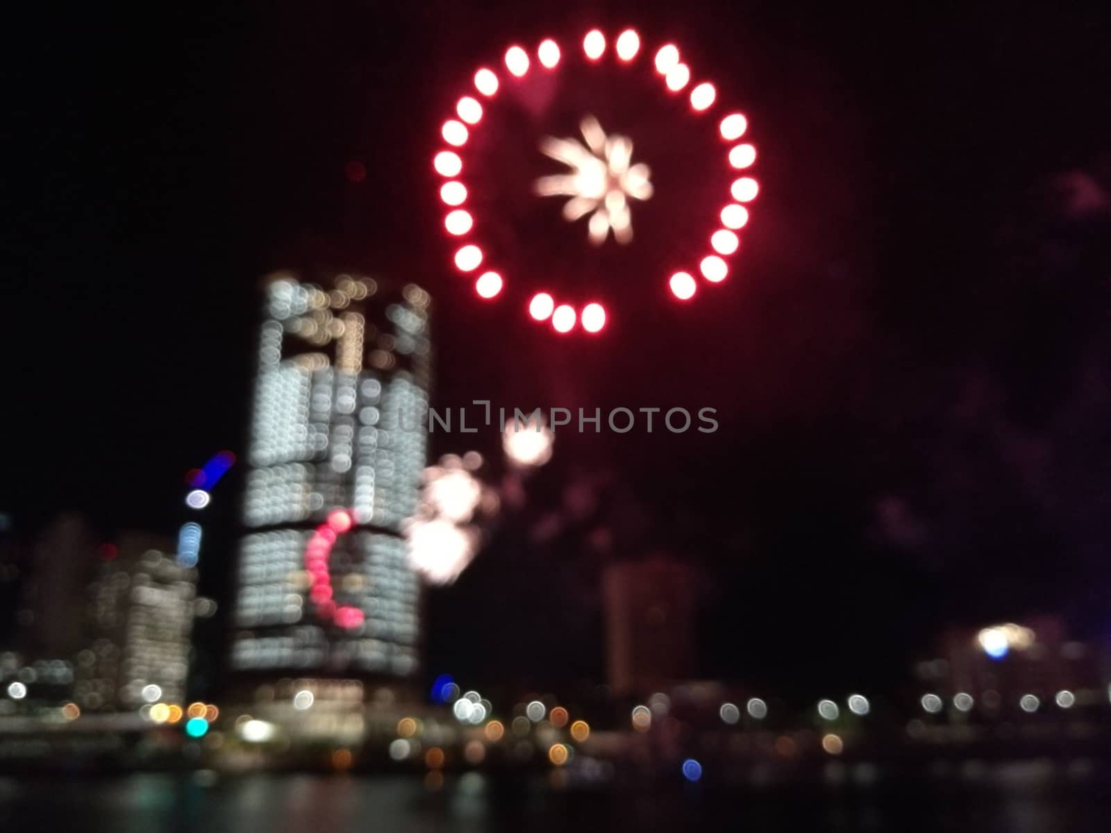 Defocused abstract scene of riverside firework in city center at by eyeofpaul