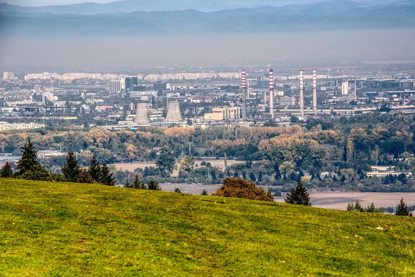 Industrial view of a capital city with chimneys and visible smog, landscape city photo