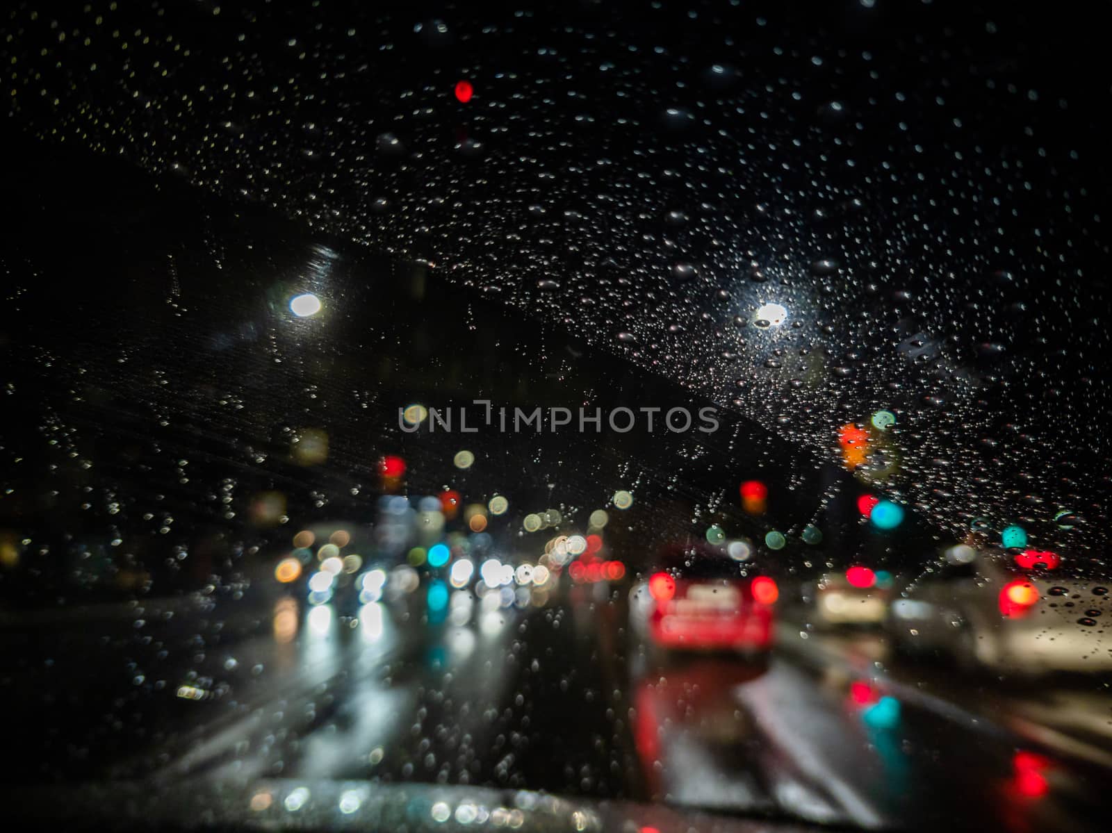 defocused photo of night driver view on city from right steering car - short sightness problem