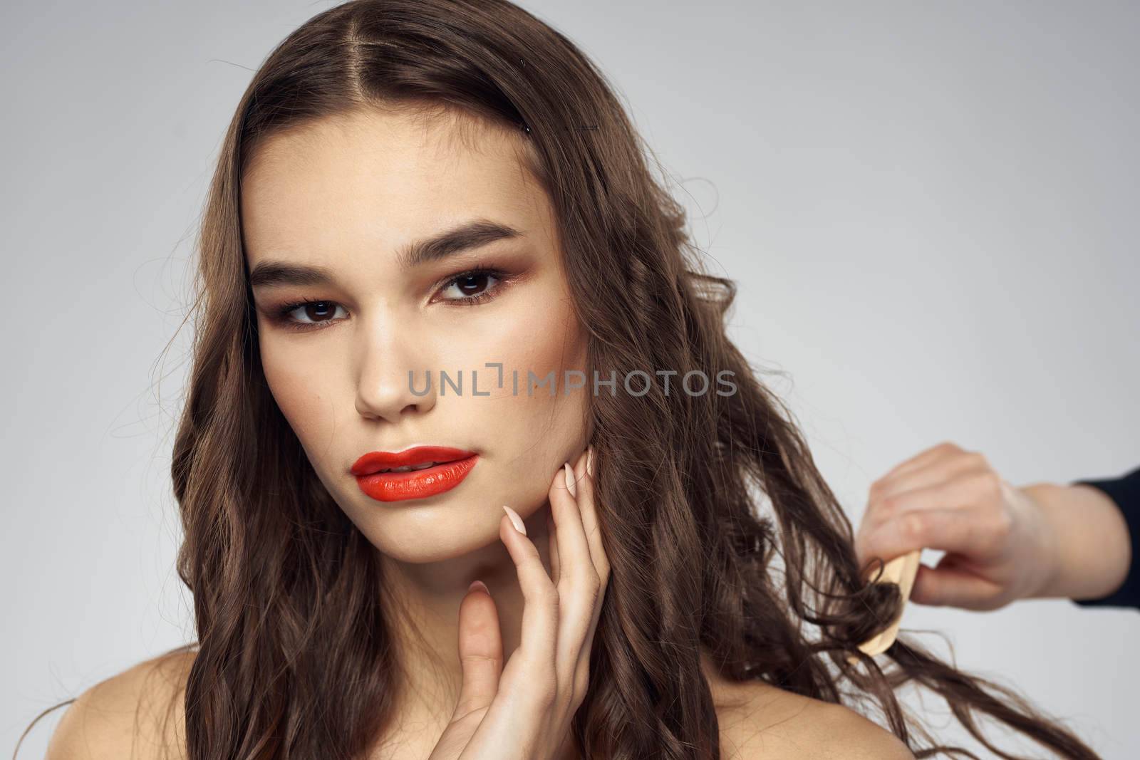 Beautiful woman fashionable hairstyle grooming naked shoulders bright makeup. High quality photo