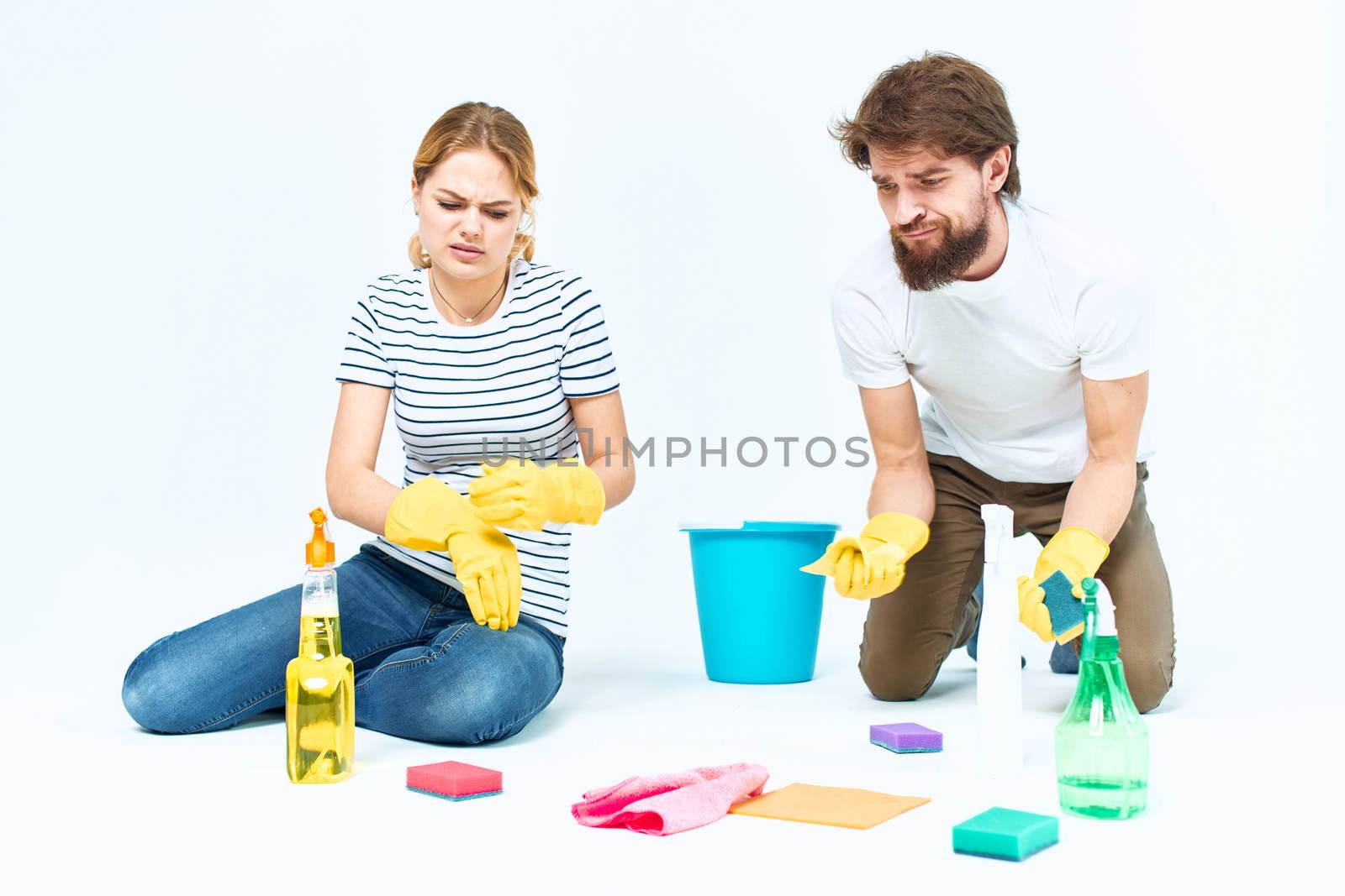 Young couple wash floors at home interior light background lifestyle. High quality photo