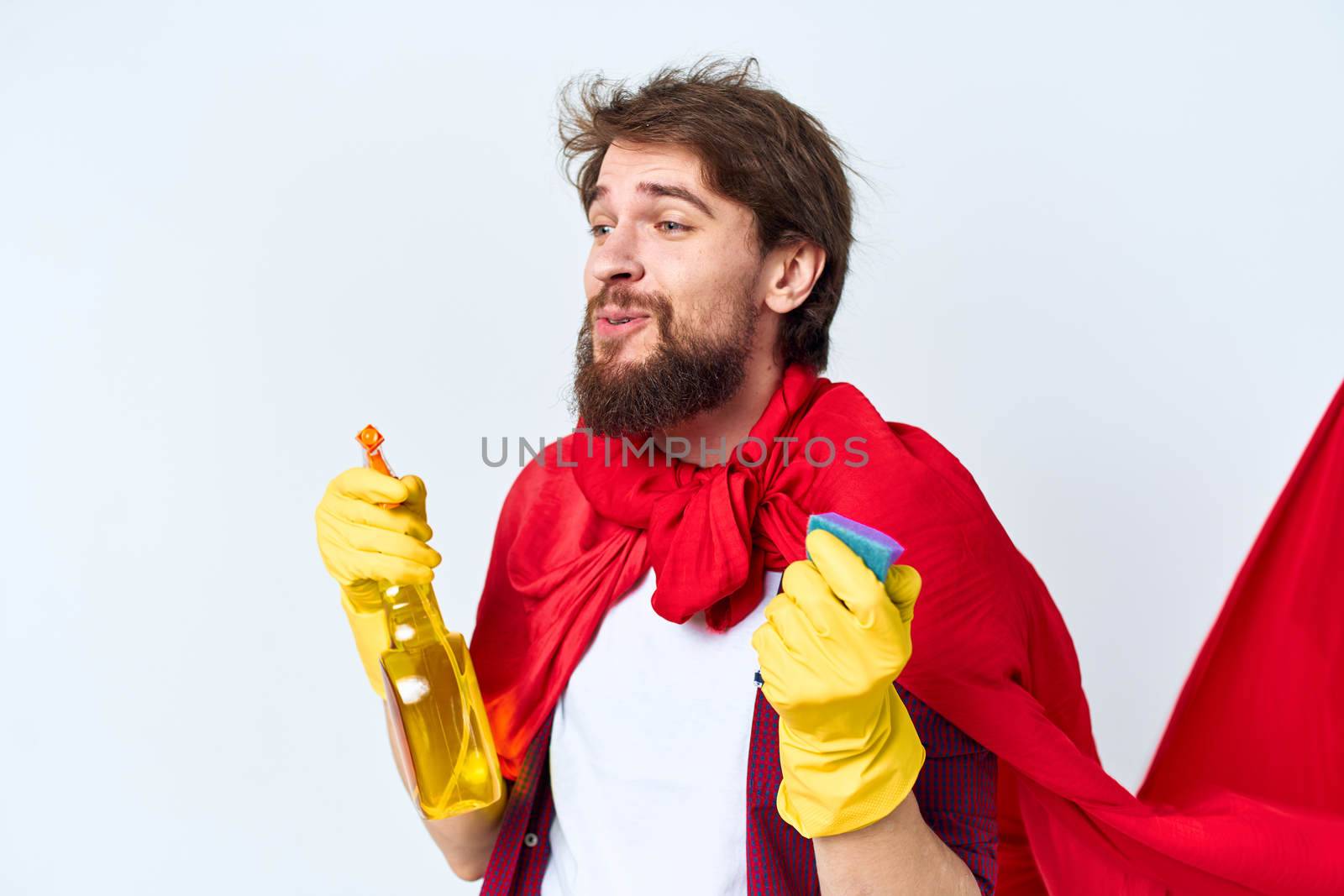 Cheerful male cleaner professional red raincoat housework lifestyle light background. High quality photo