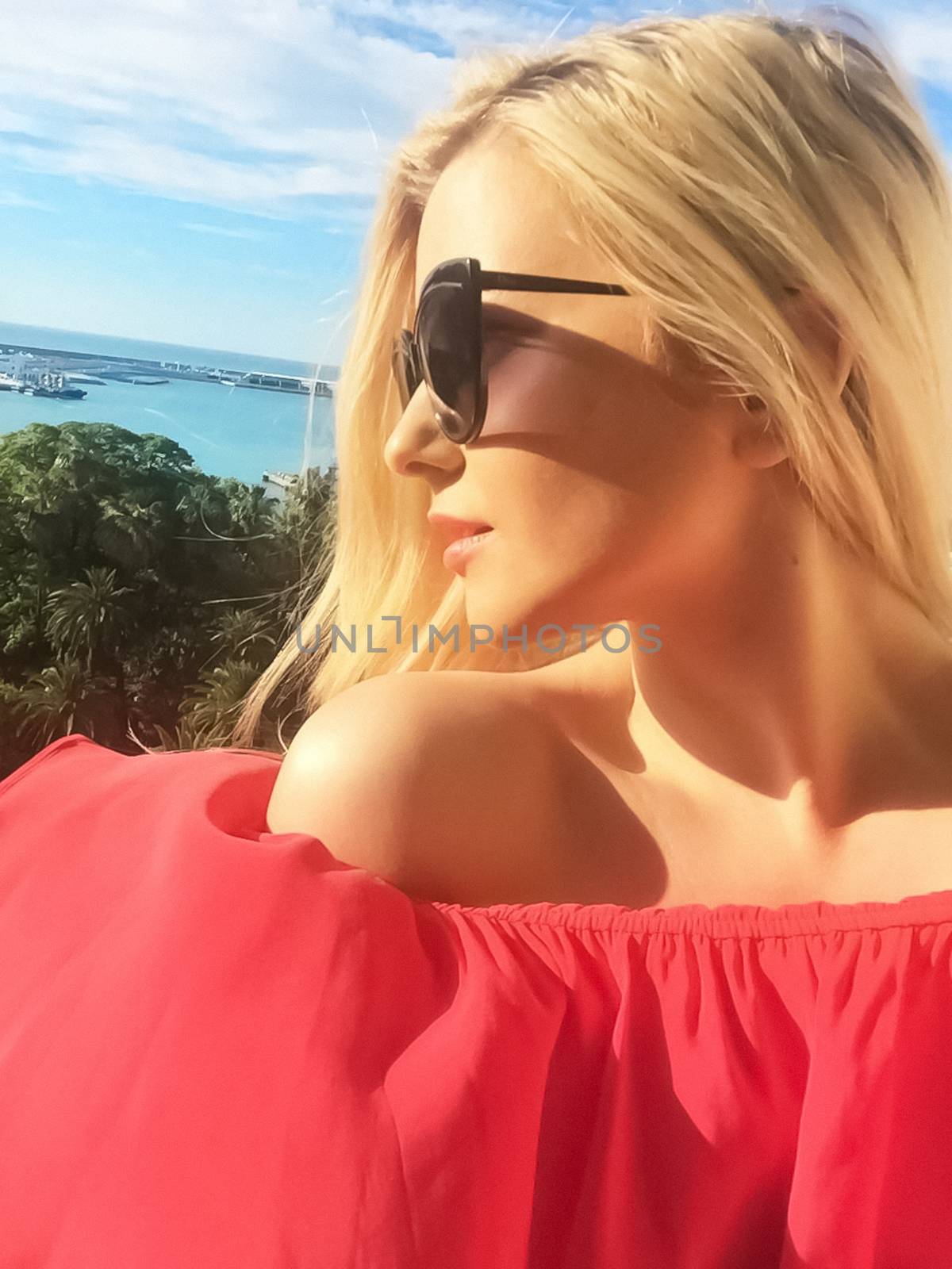 Red summer dress and chic sunglasses, beautiful model woman on vacation and travel at the seaside, luxury fashion and beauty brands