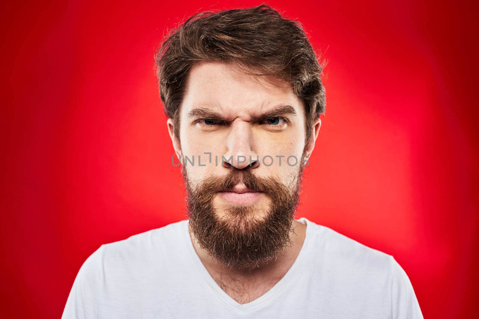 man in t-shirt gesturing with his hands dissatisfaction studio red uniform. High quality photo