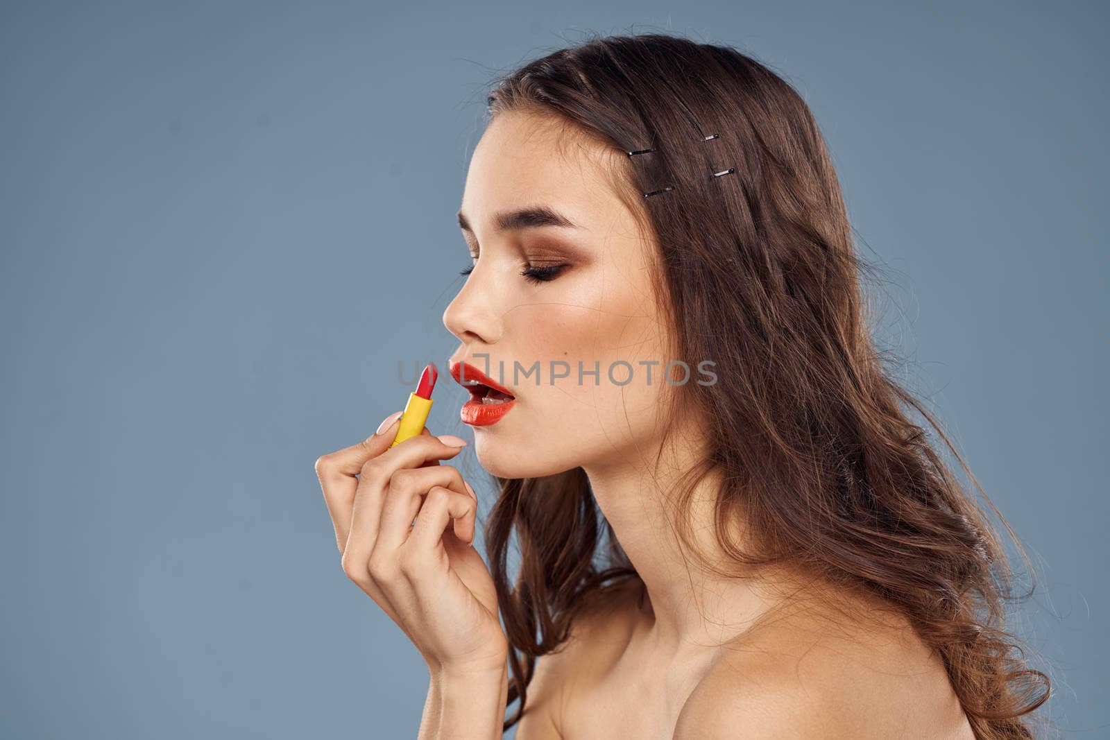 Woman with lipstick on a gray background brunette makeup with eye shadow on the eyelids by SHOTPRIME