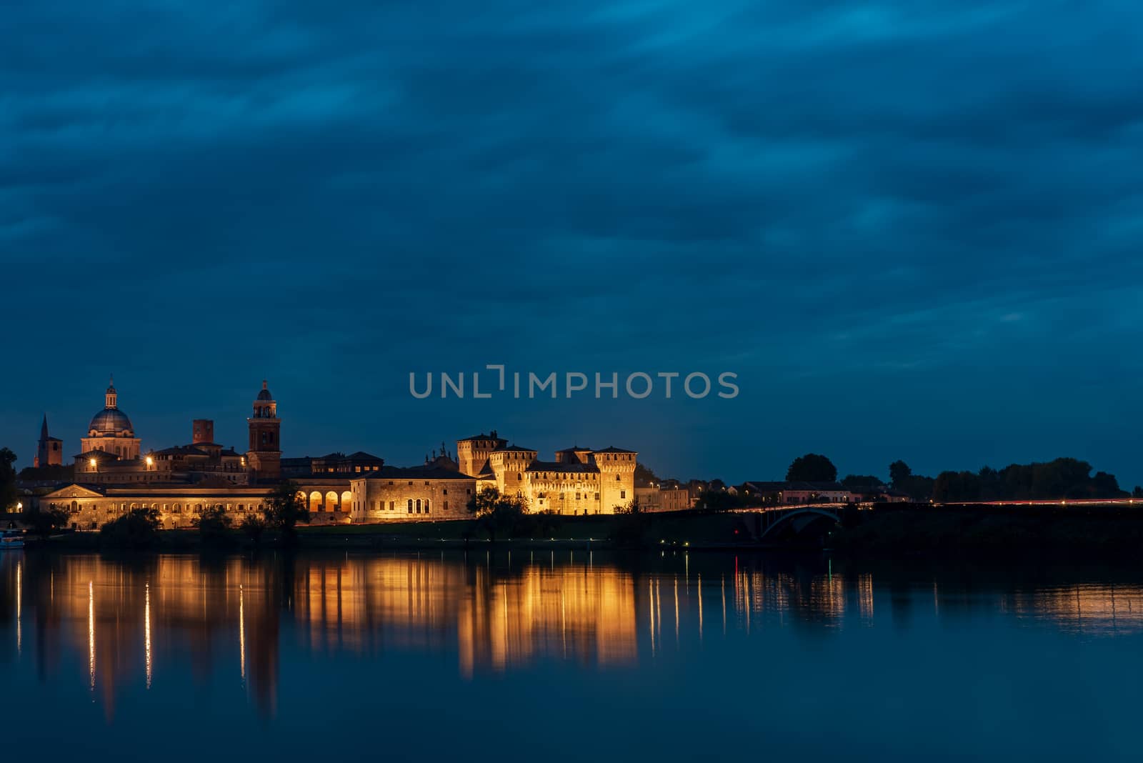 Panorama of the city of Mantua illuminated and reflected in the  by brambillasimone