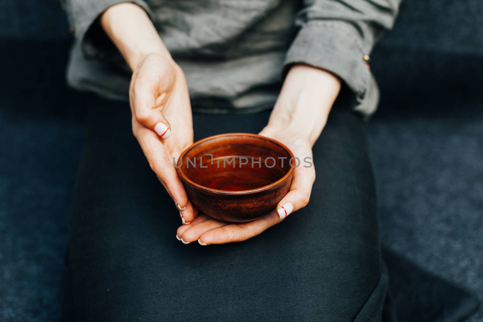 Woman offers hot tea in a vintage ceramic cup. Traditional tea ceremony